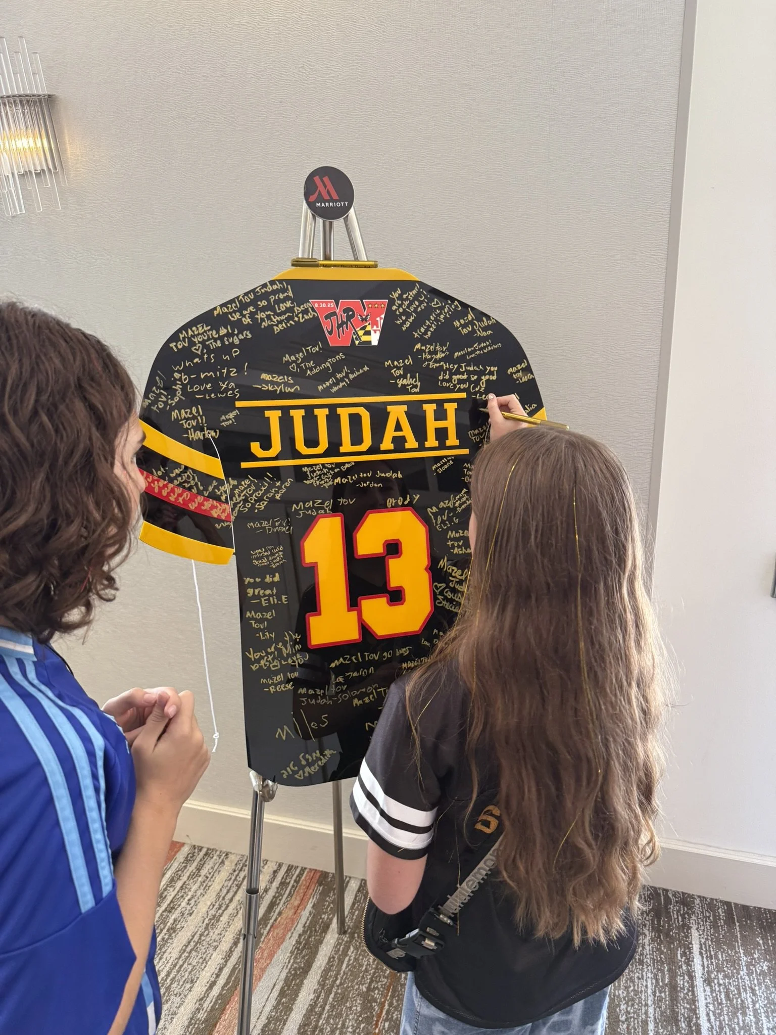 Custom black football jersey with red and yellow detailing.