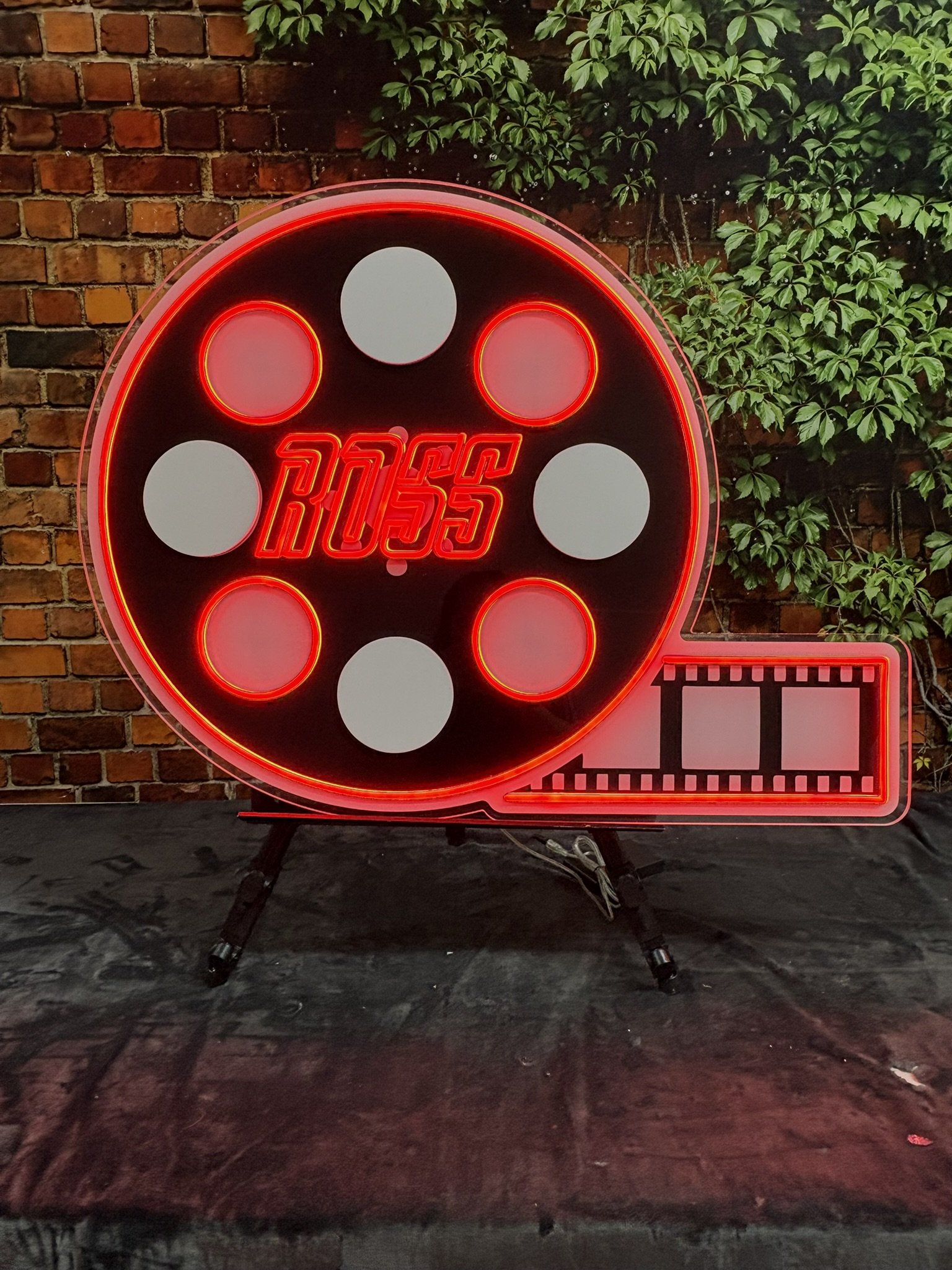 Movie reel neon sign in board_Red_Black_Bar.JPEG