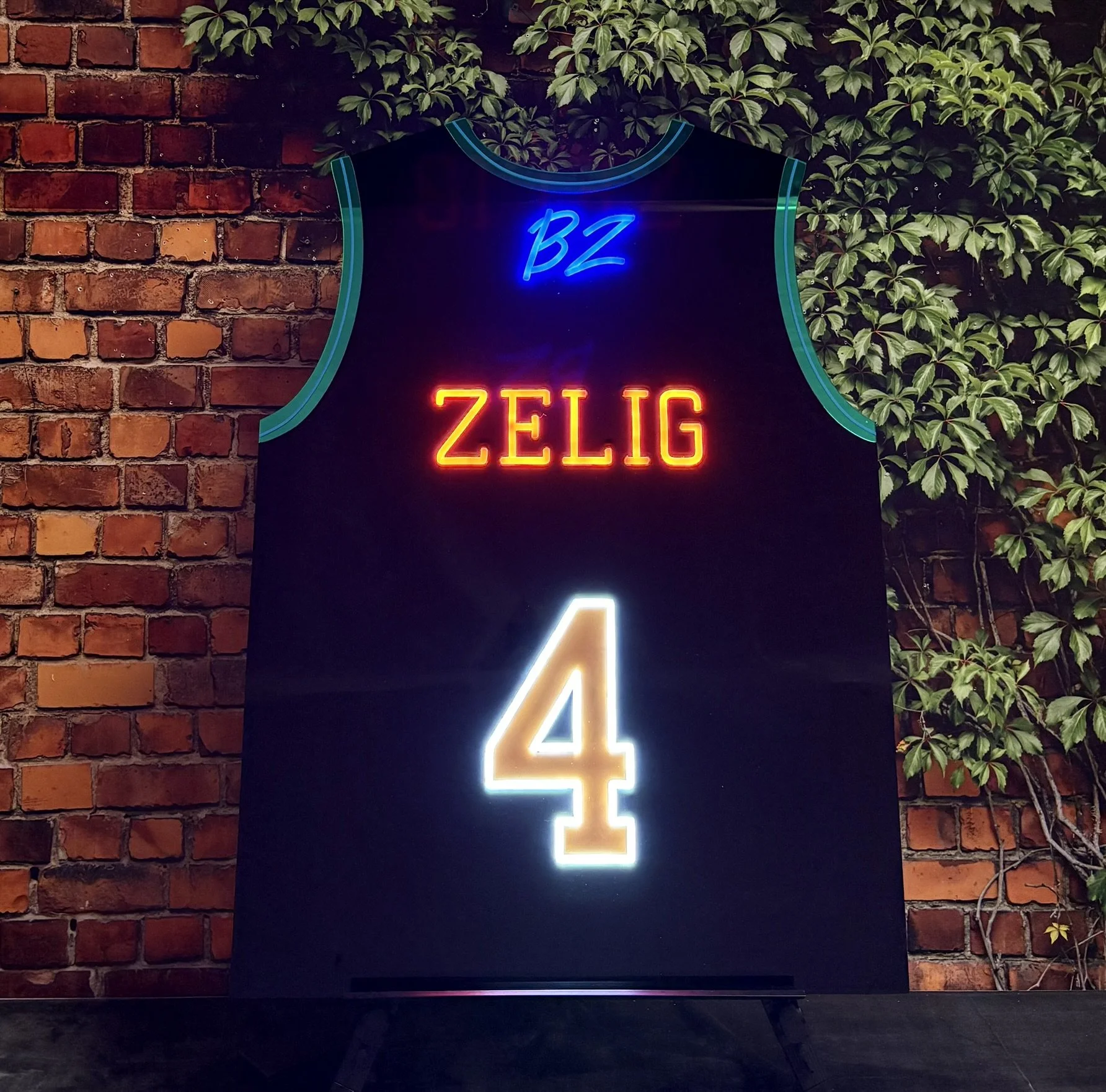 Black basketball jersey sign-in board with neon accents.