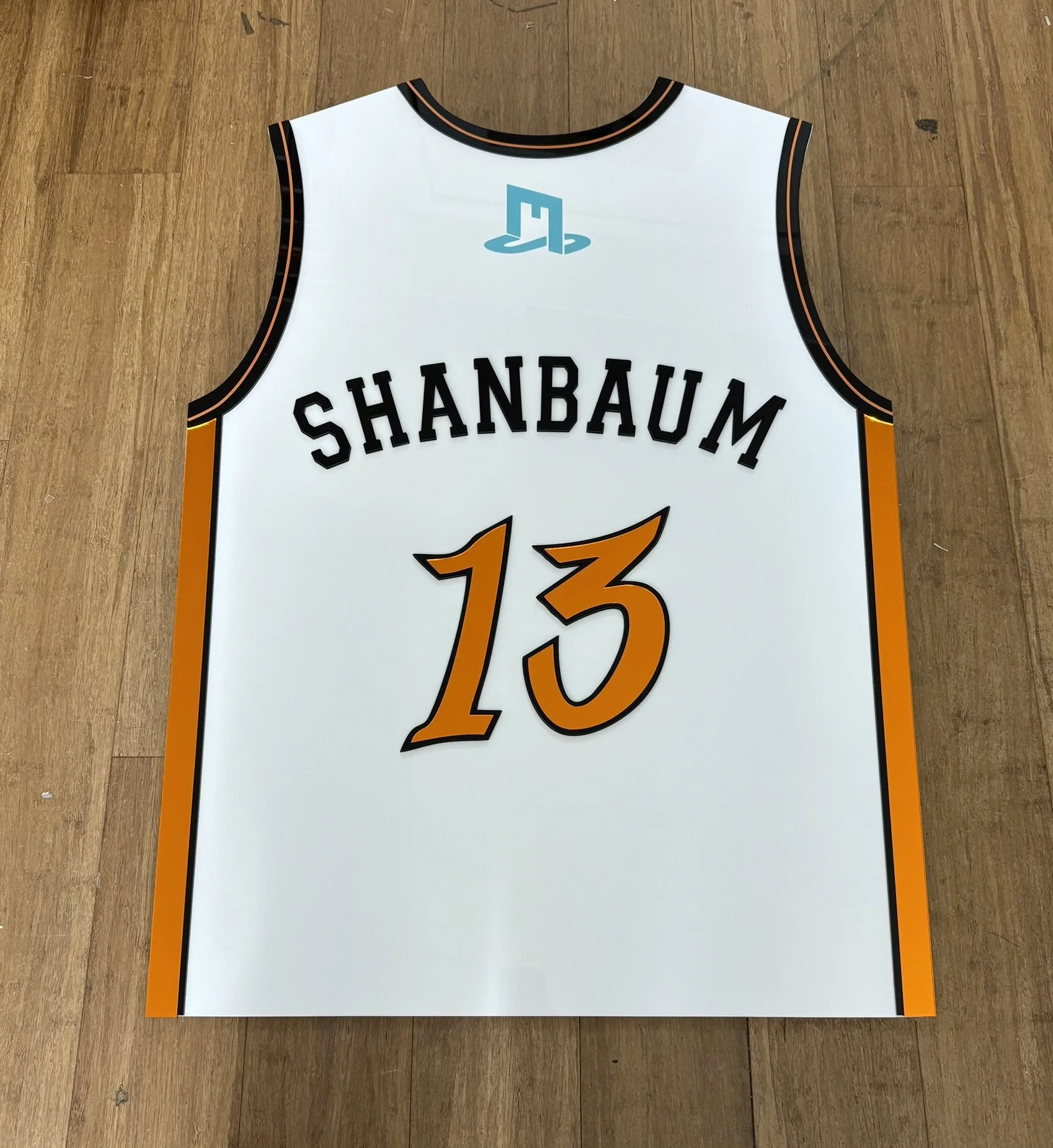 Custom basketball jersey sign-in board with orange accents.