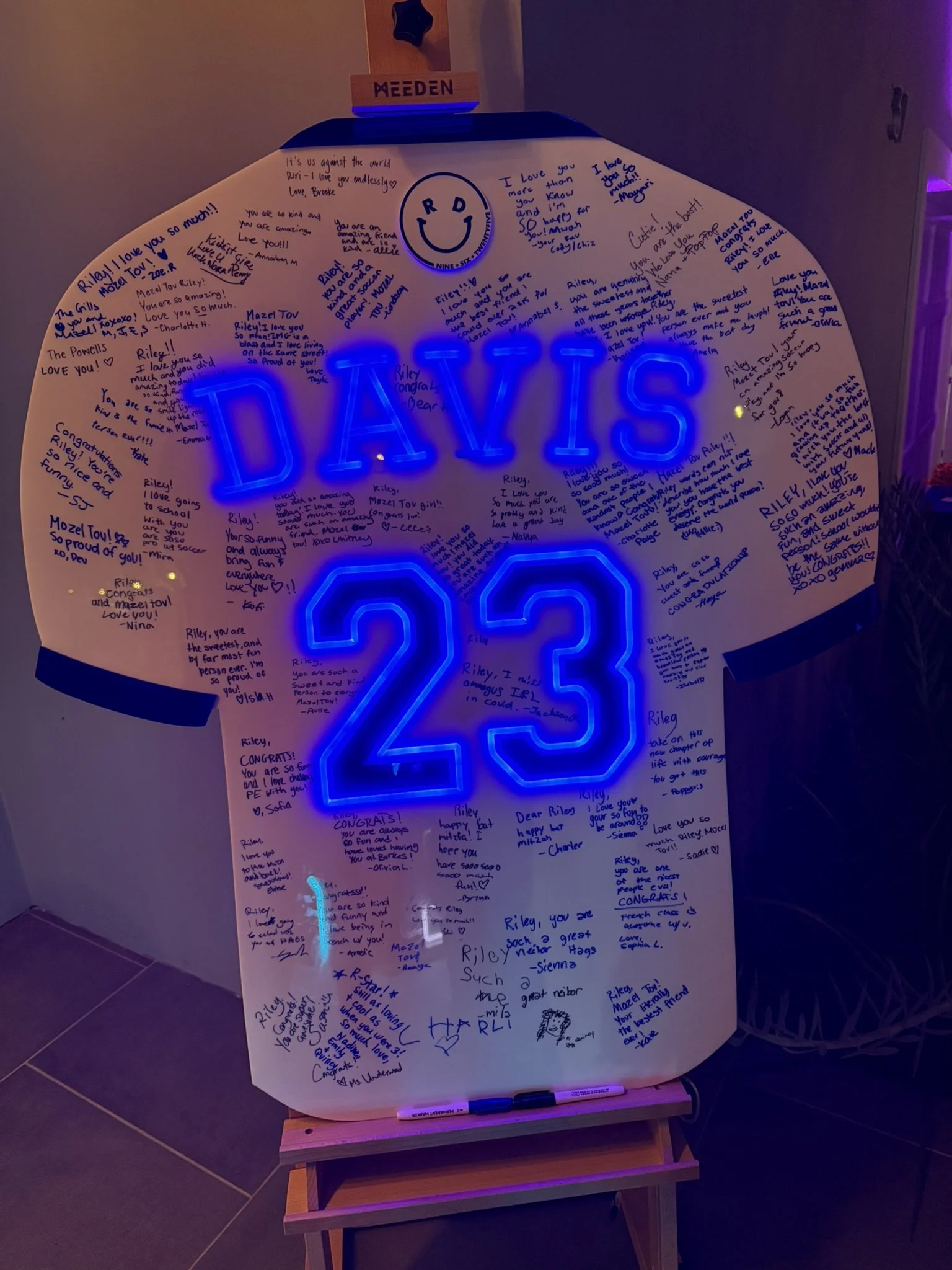 Custom football jersey sign-in board with blue neon. 