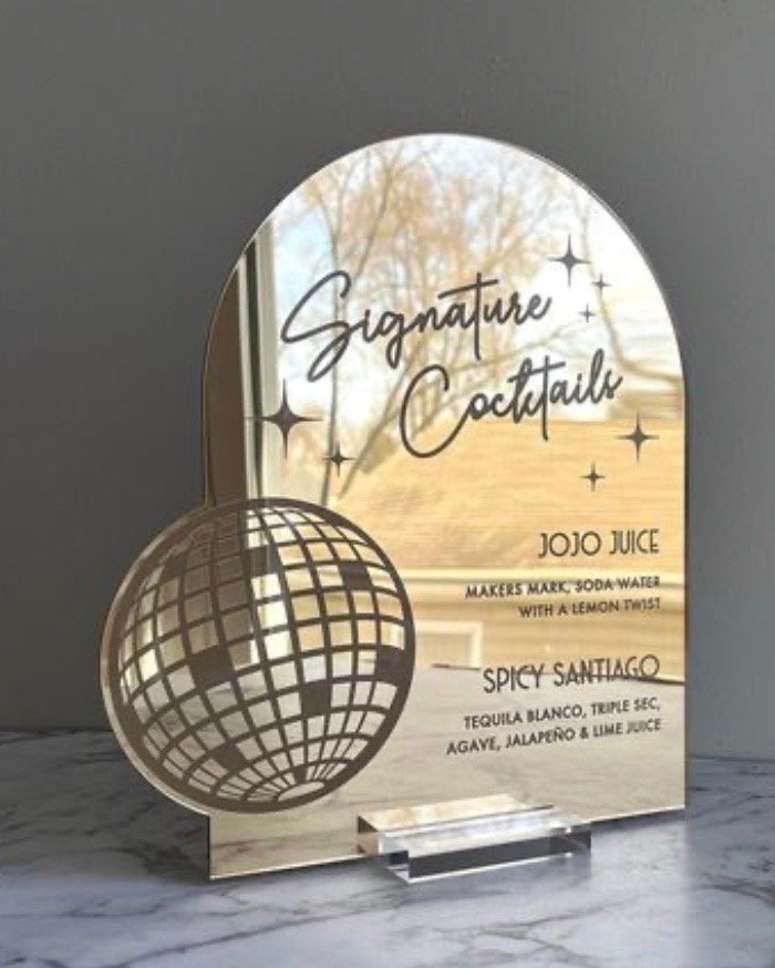 Custom mirrored acrylic disco drink menu with a disco ball. 