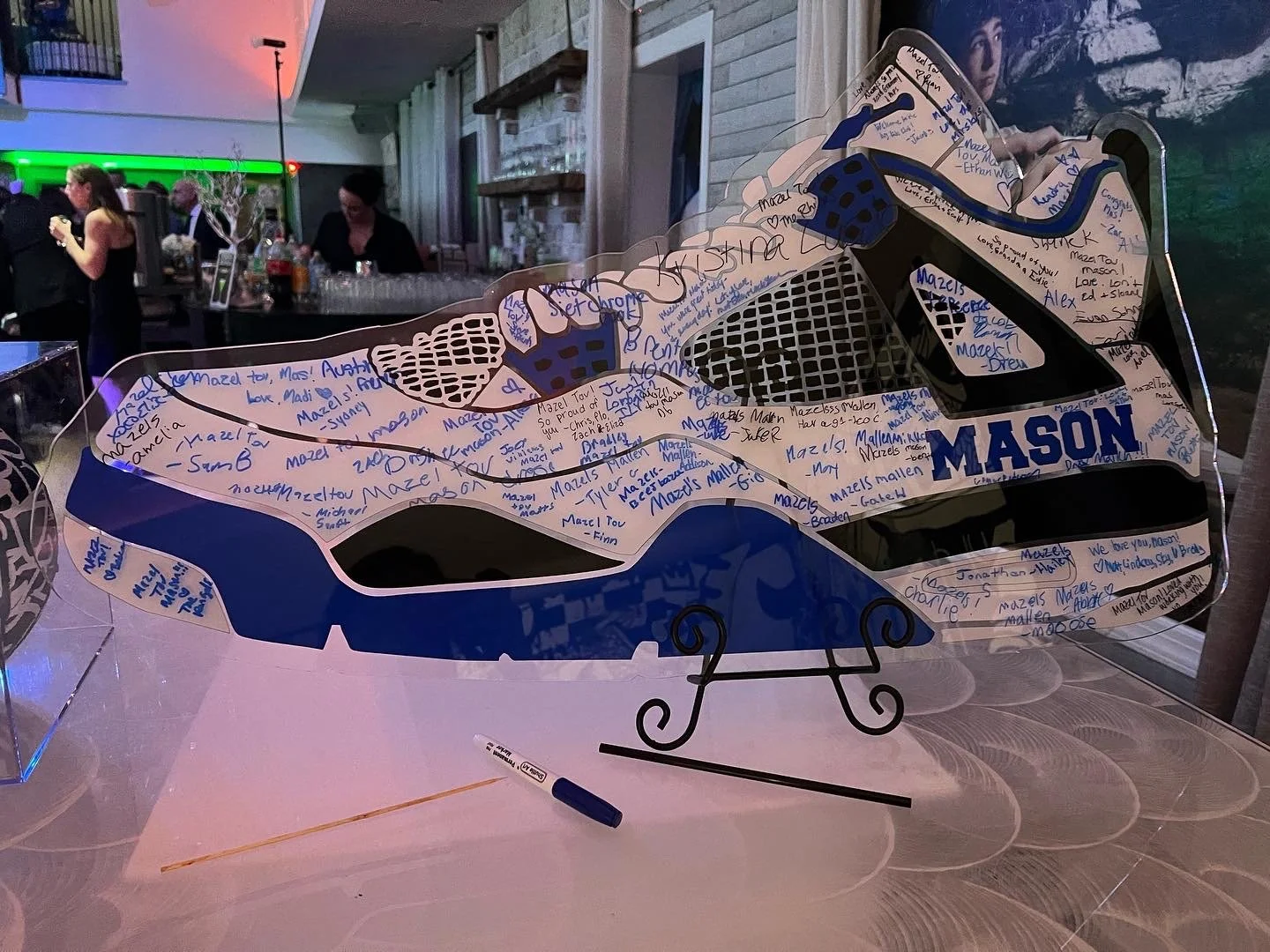 Blue, black, and white custom sneaker sign-in board.