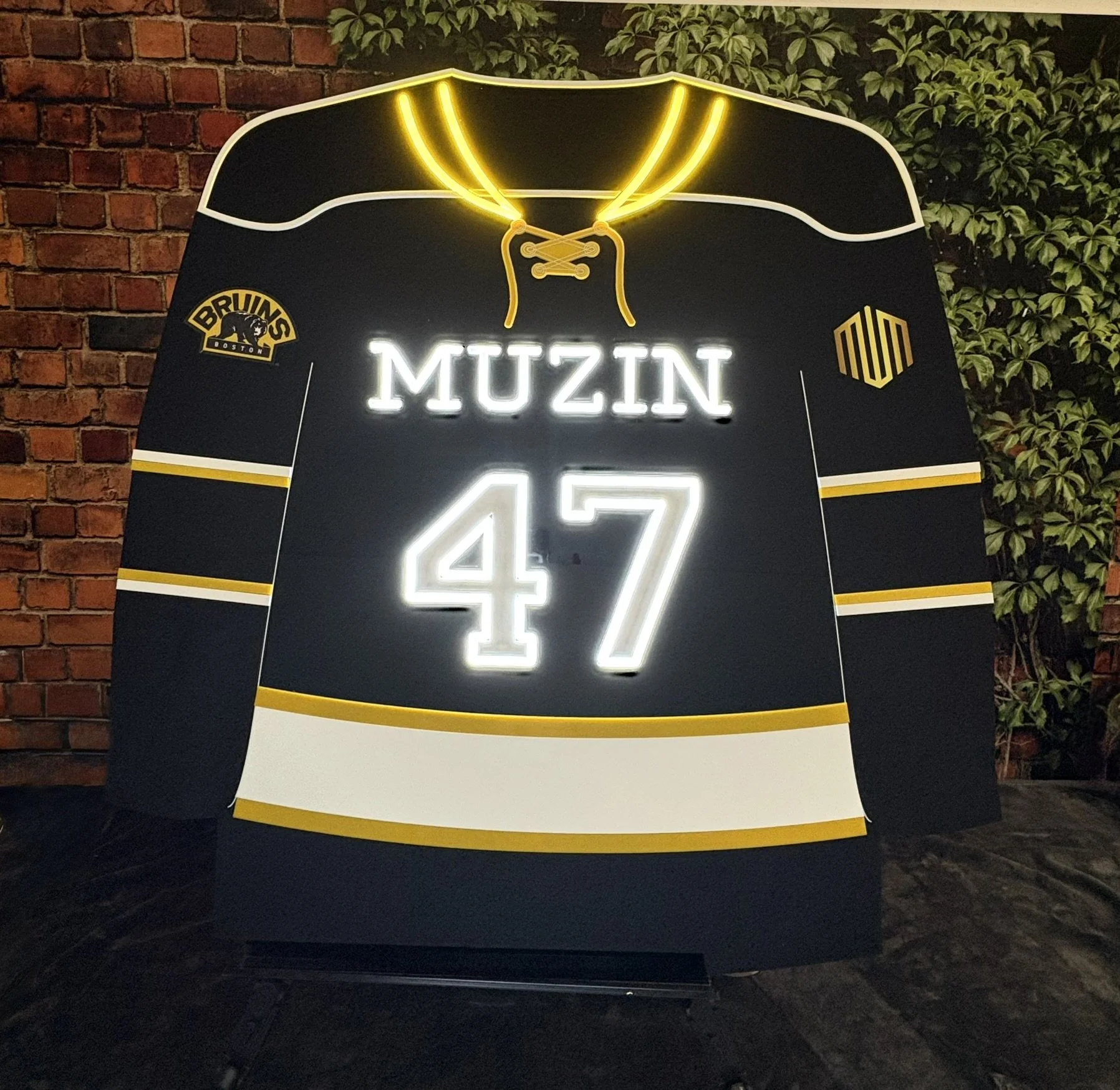 Black custom hockey jersey with yellow and white accents.