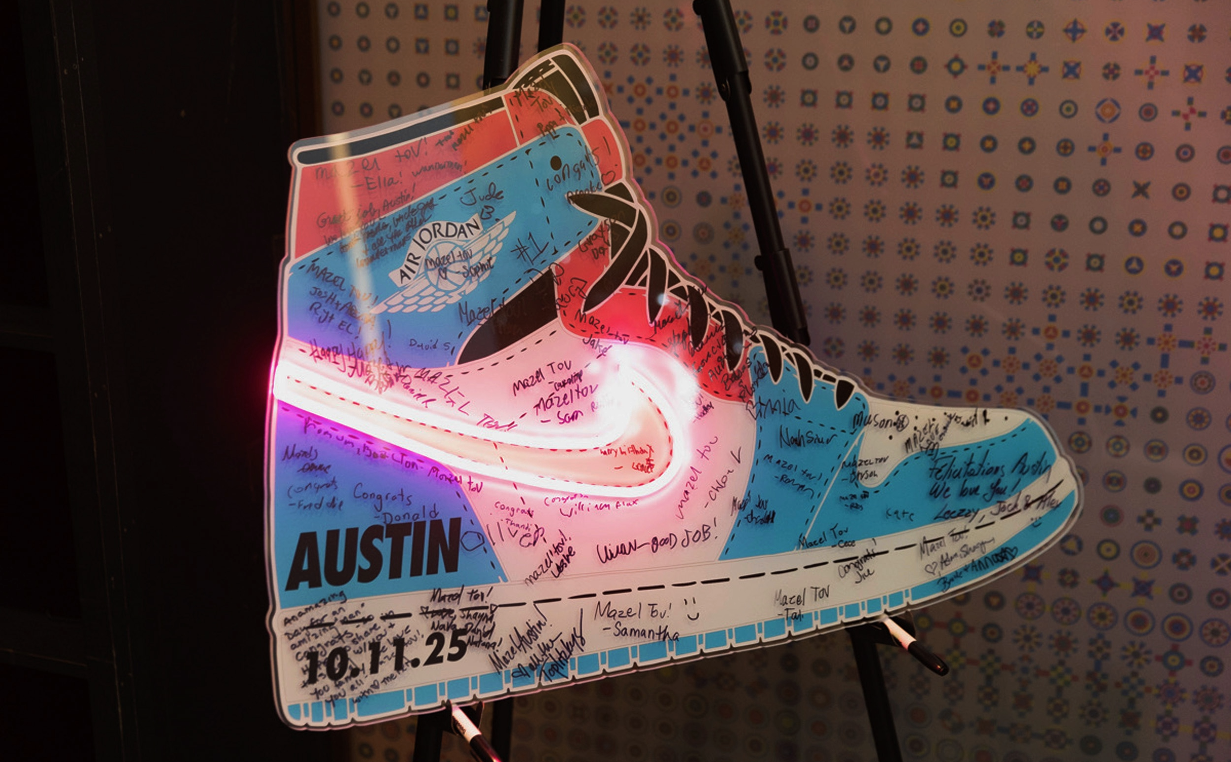 Custom blue and pink Nike Air Jordan sneaker sign-in board with pink neon.