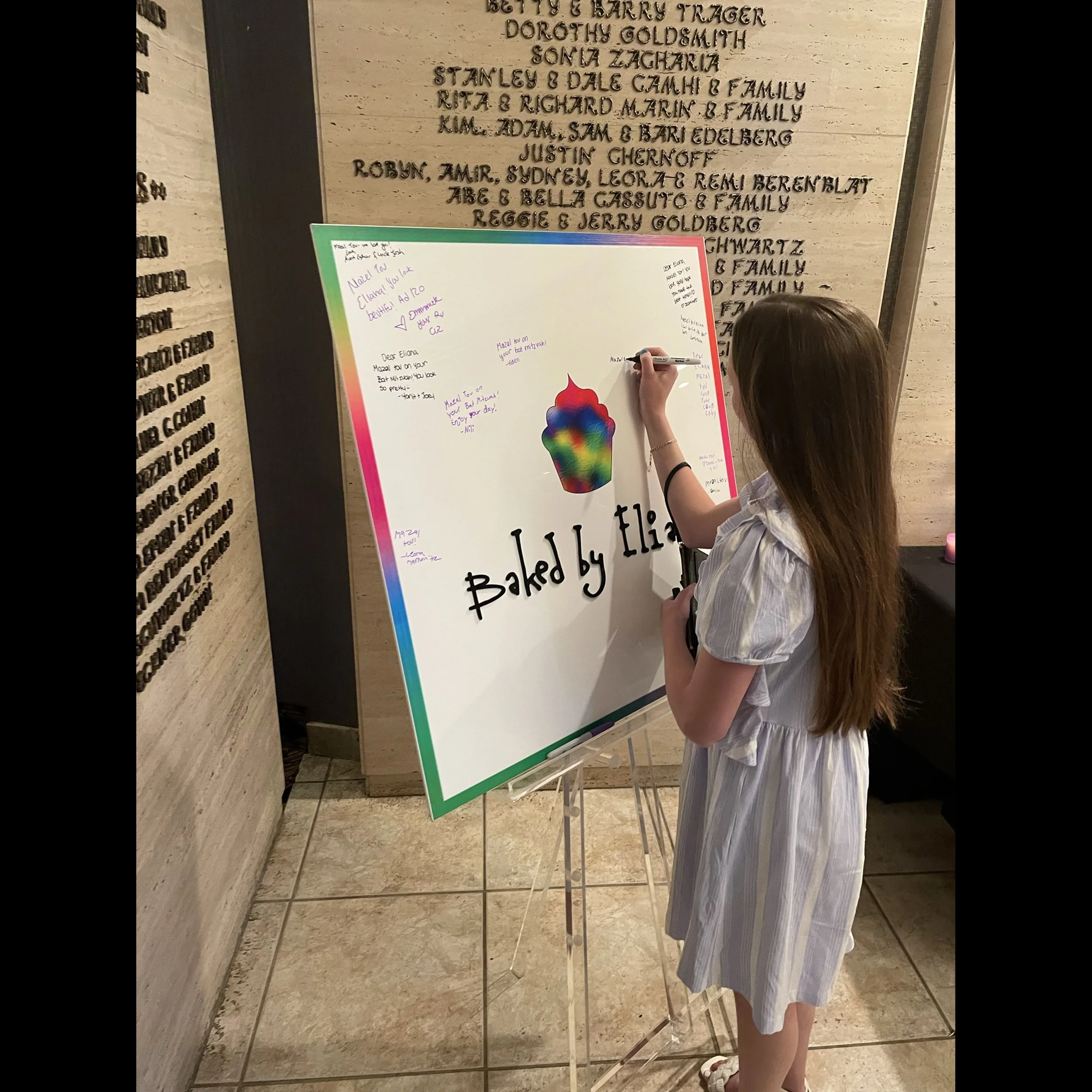 Baked by Eliana Logo White Board Being Signed.jpg