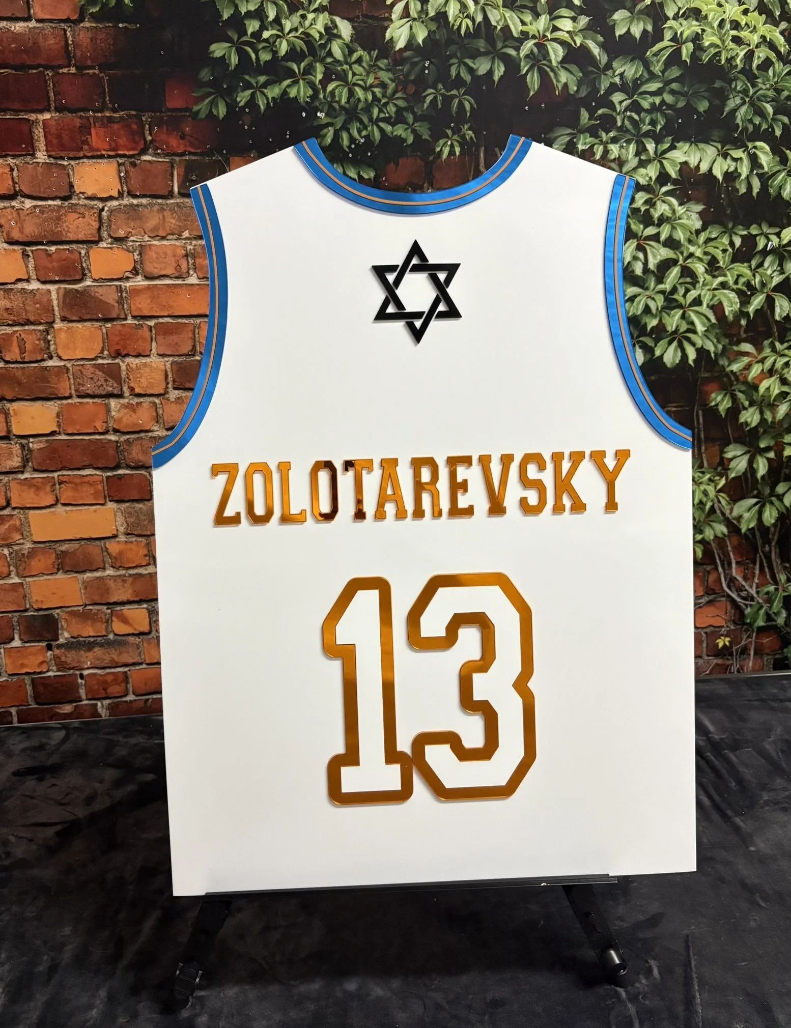 Custom basketball jersey sign-in board with blue and red accents.