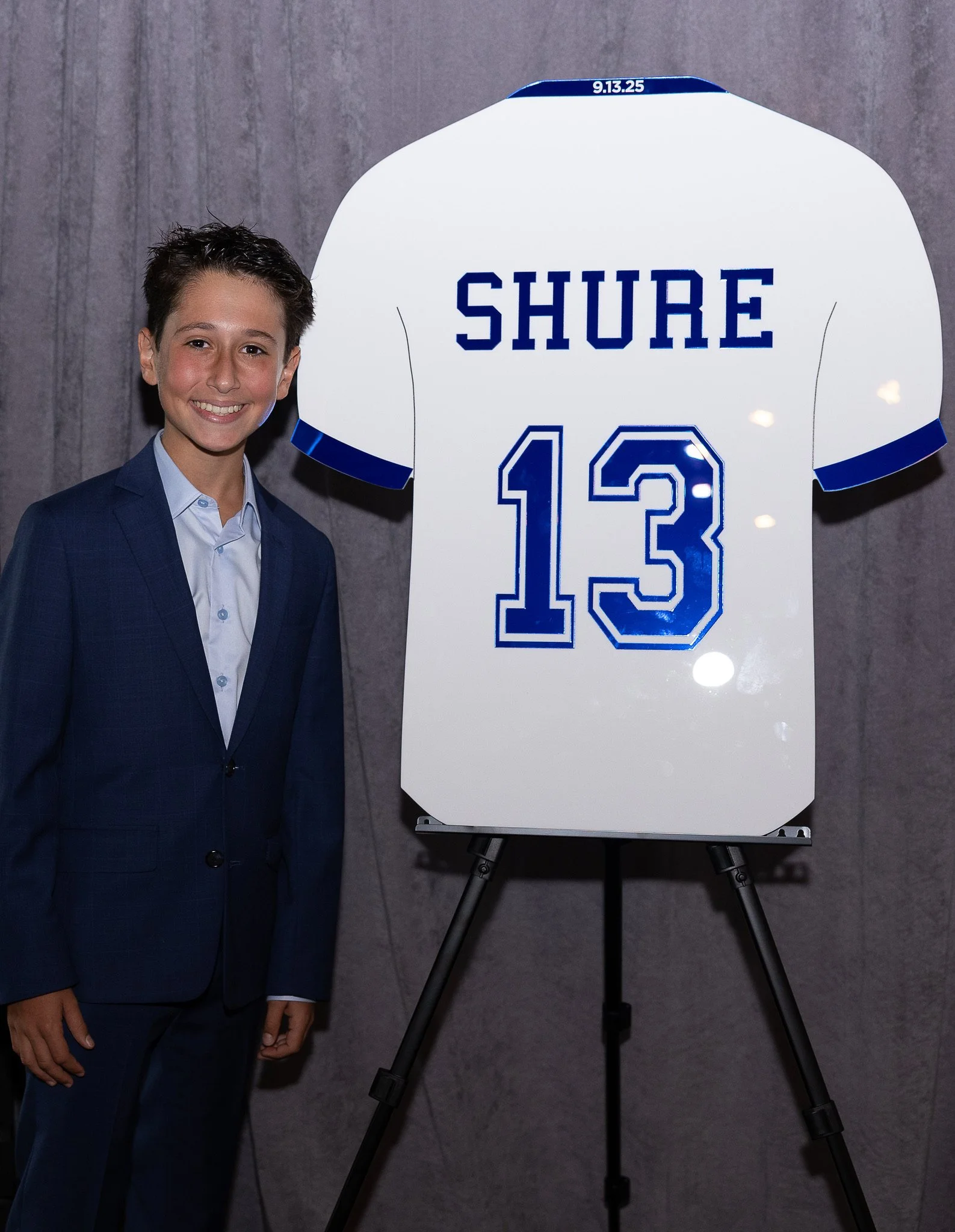 Custom blue and white football jersey sign-in board.