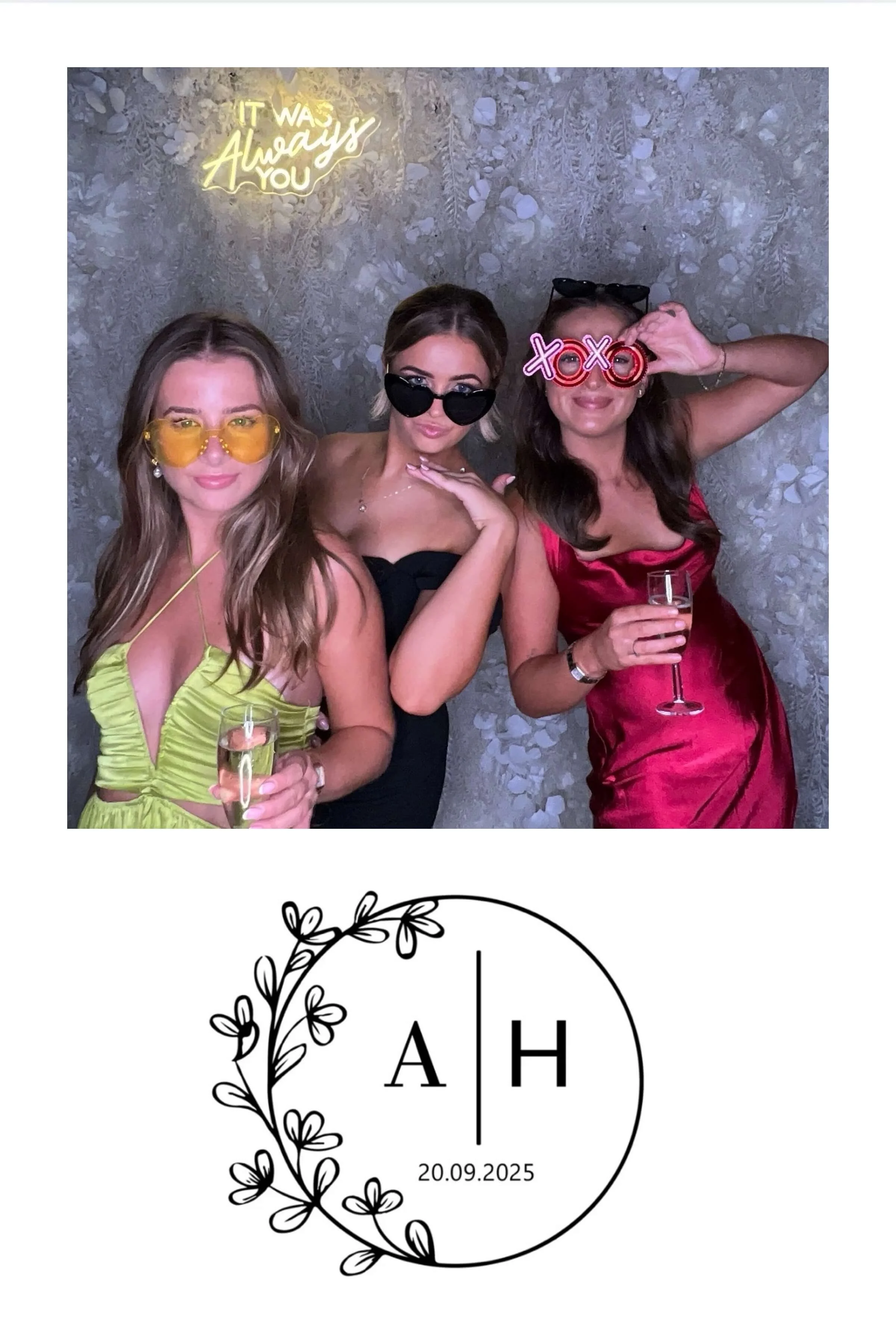 Three women in colorful dresses and sunglasses celebrating with drinks at a party. The background has a floral wall with a neon sign saying 'It was always you.'