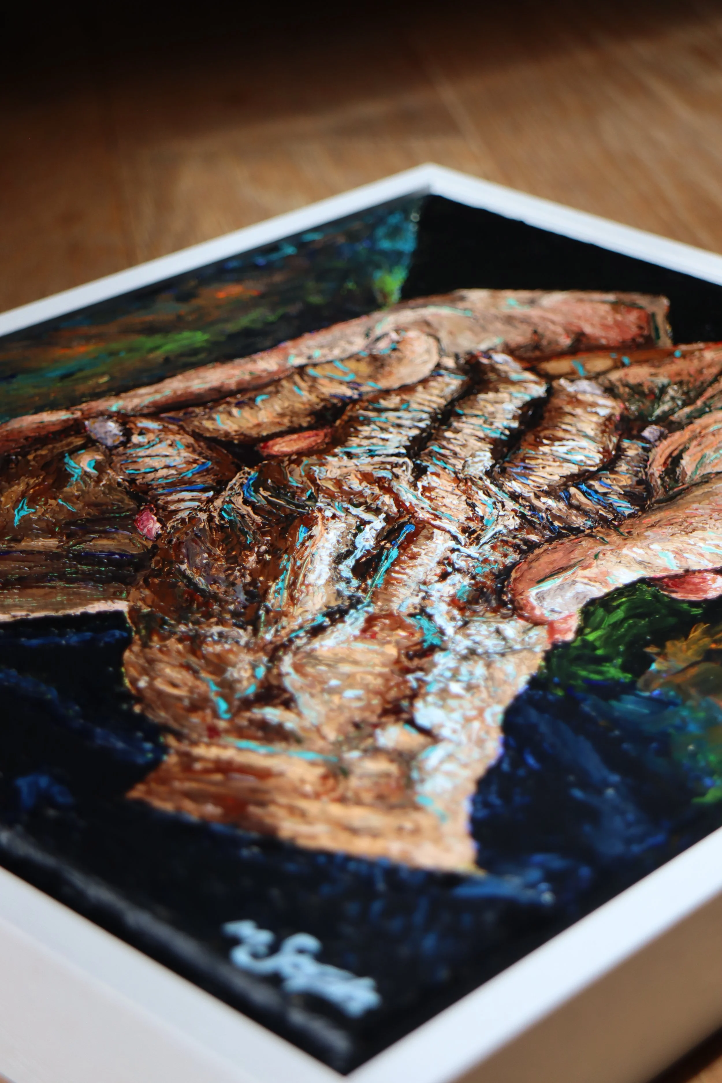 Close-up of a painting of two hands, one elderly and one younger, with detailed, textured brushstrokes, set within a white frame.