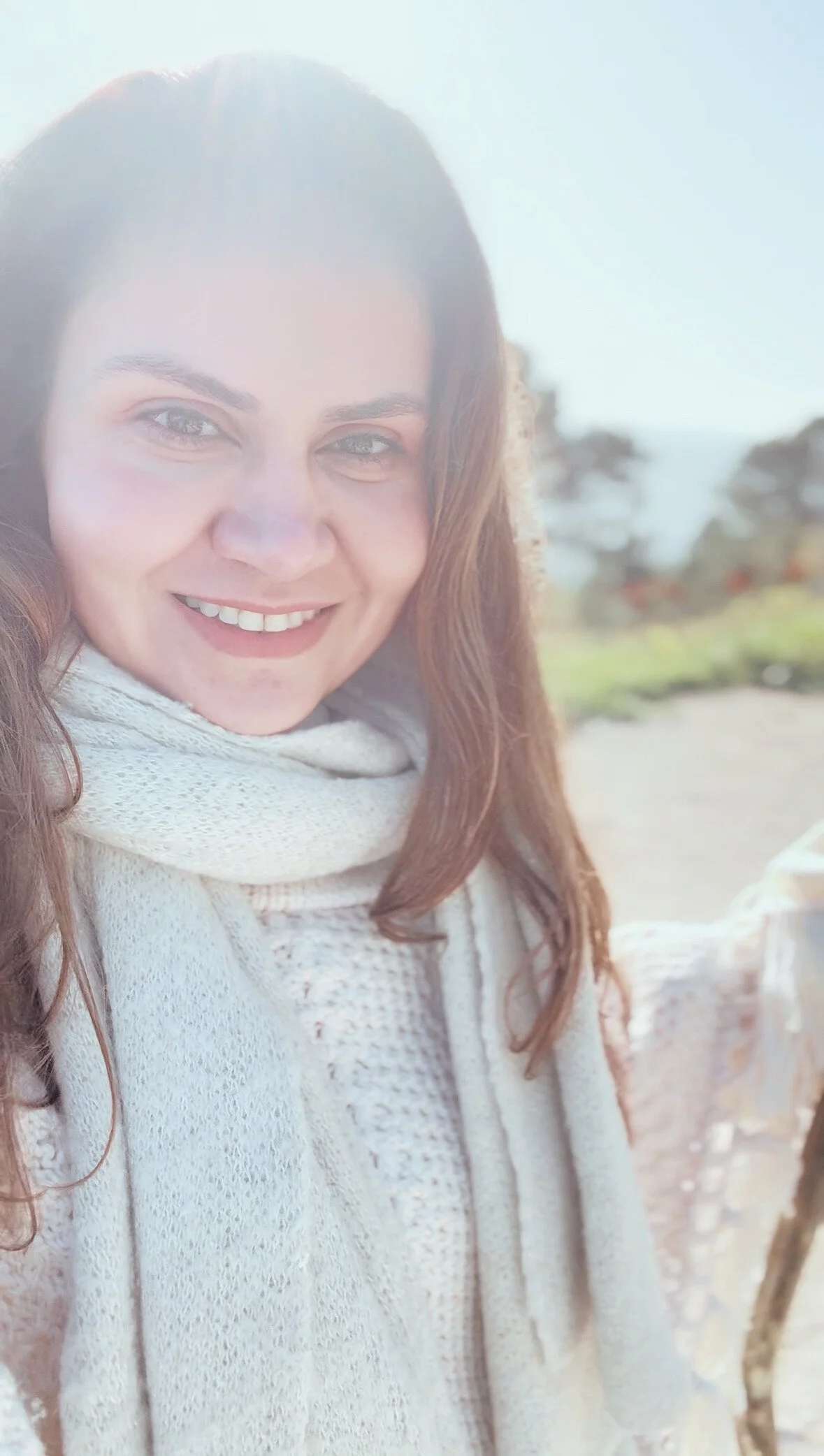 Woman sitting by the ocean in a peaceful setting