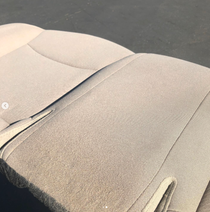 Close-up of a beige cushioned seat outdoors.