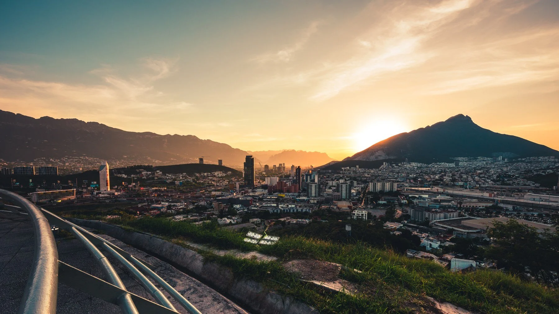 Monterrey at sunset, with the Sierra Madre behind the city. Monterrey is one of the main destinations for nearshoring employee relocations in Mexico.