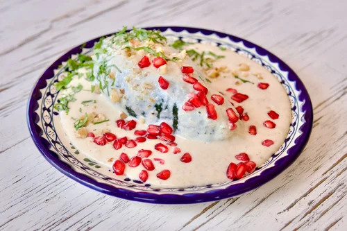 Chiles en nogada, a traditional Mexican dish, on a talavera plate
