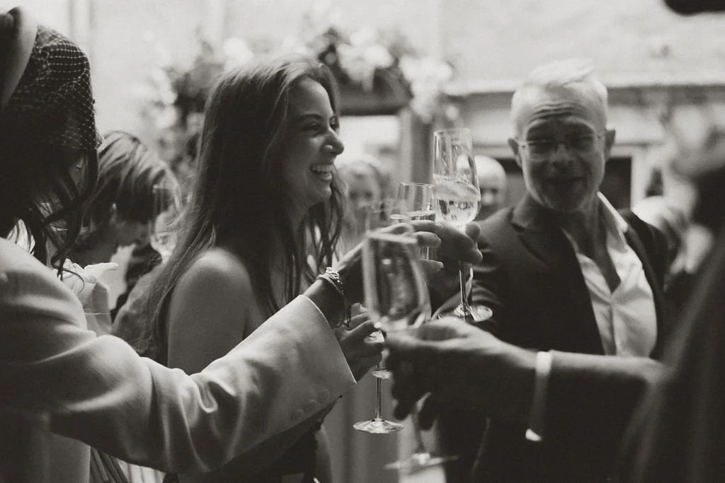 People raising glasses in a toast at a celebration or party.