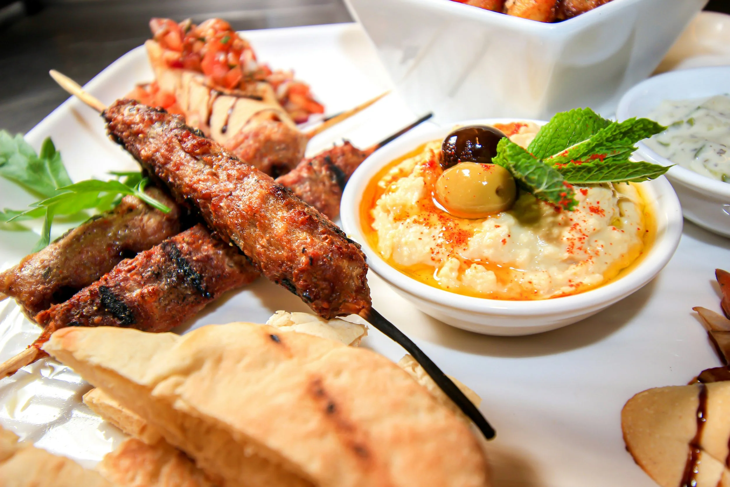 Mixed grill met souvlaki, pita brood, hummus en olijven bij Heraklion Gyros & Grill in Den Haag, authentiek Grieks eten