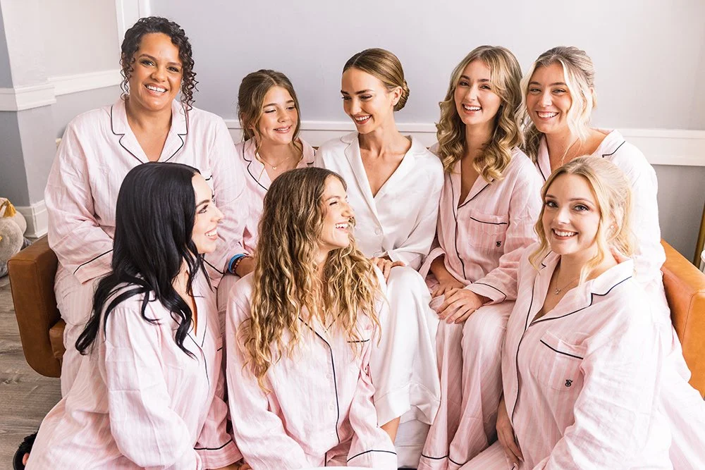 Bride poses with her bridesmaids in St. Augustine, Florida in the Tower Suite getting ready space. 