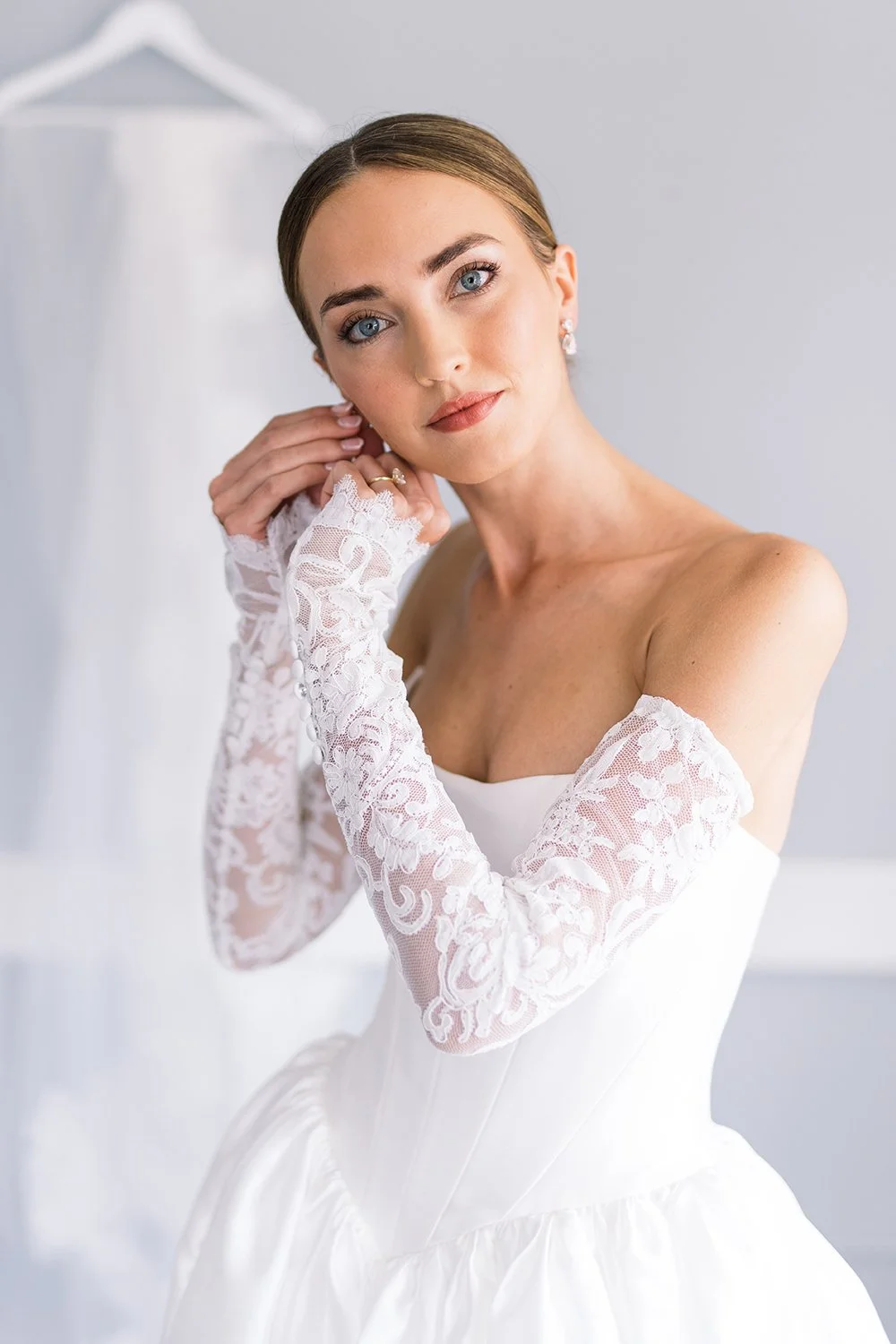 Bride adds finishing touches to her wedding day look.