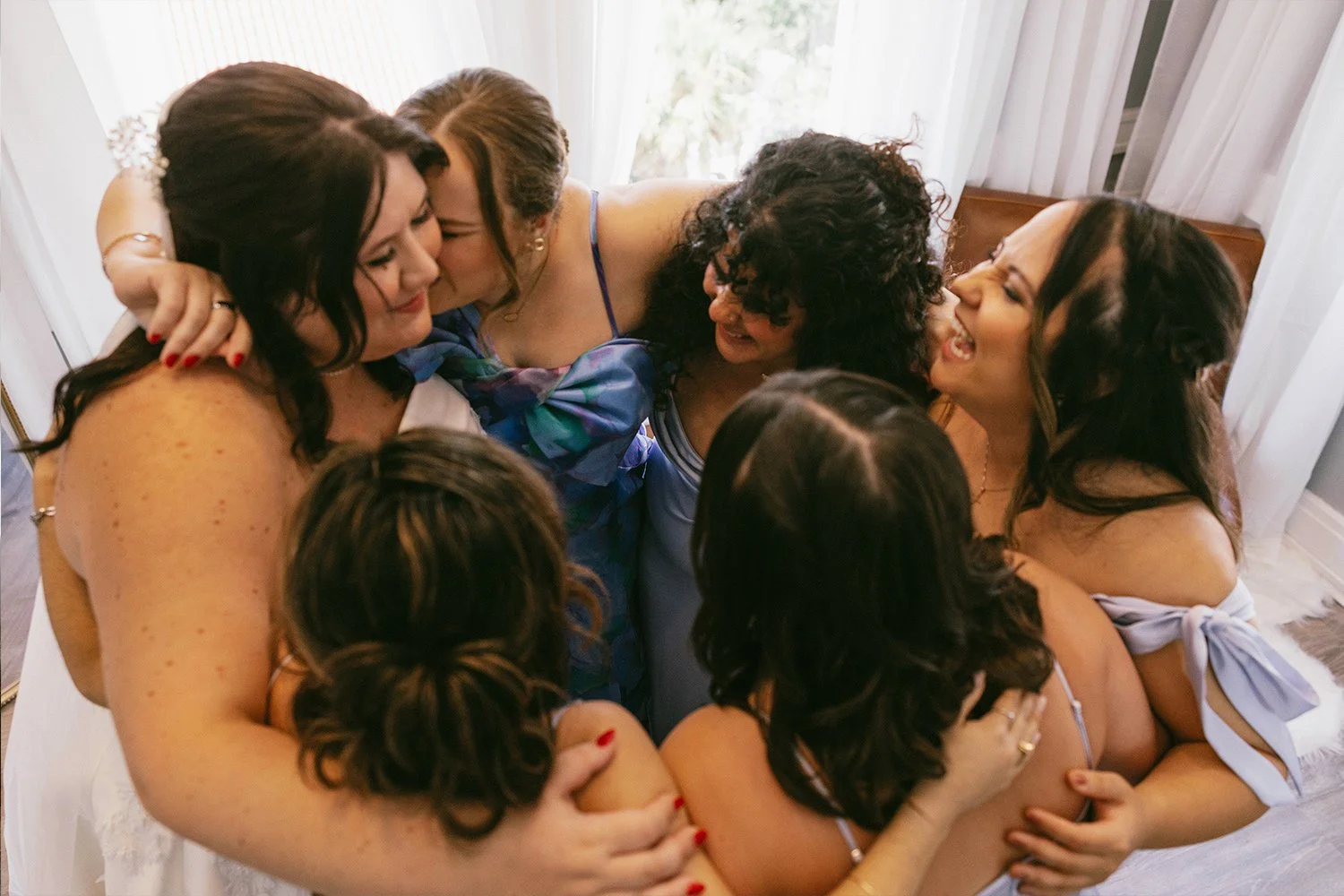 Bride shares a special moment with her bridesmaids dancing in the Tower Suite on her wedding day.
