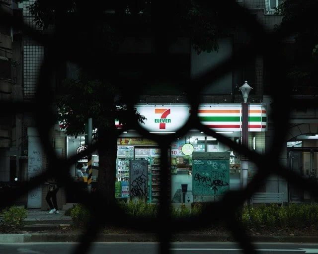 Through the iron lattice, a familiar light 💡hums in the quiet hours. 

📍Taipei, Taiwan 台北，台灣 🇹🇼

#taipeistreetphotography #streetphotography #711 #convenience #asialifestyle
