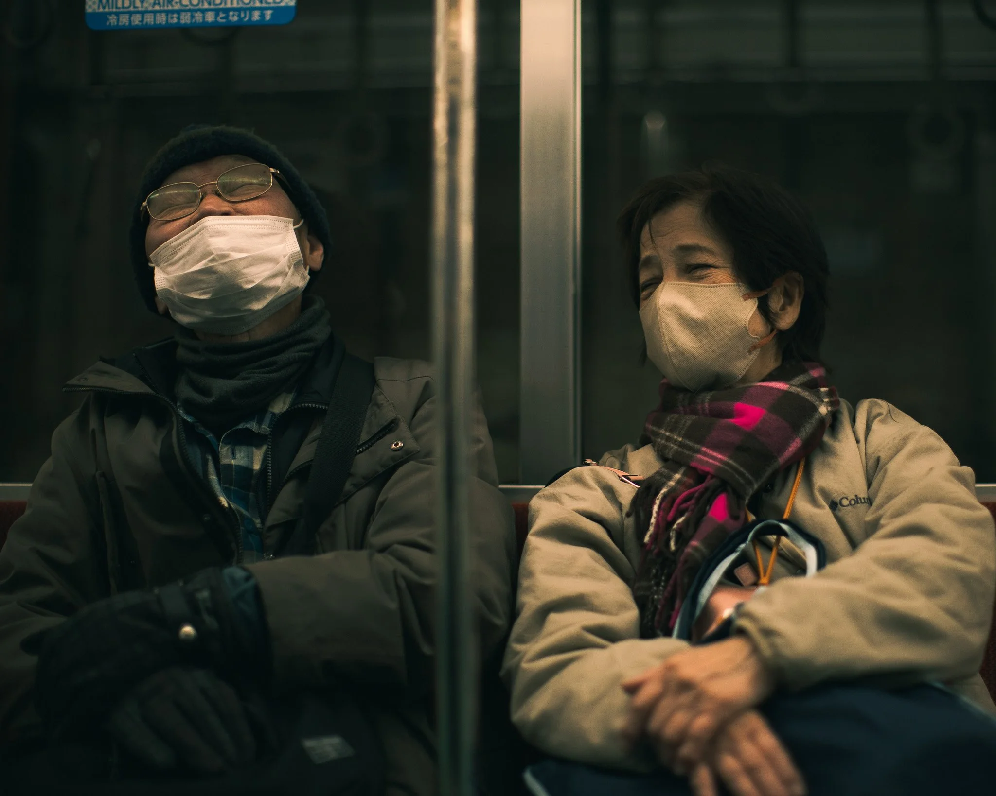kushphoto-japan-masked-commuters-sleeping-train-2025.jpg