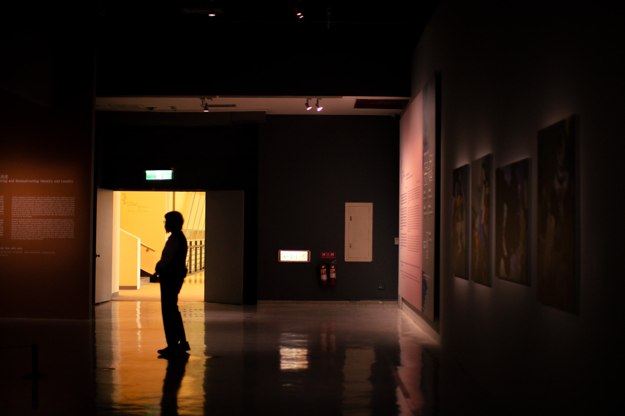 Backlit silhouette in a gallery doorway, Taiwan, 2025