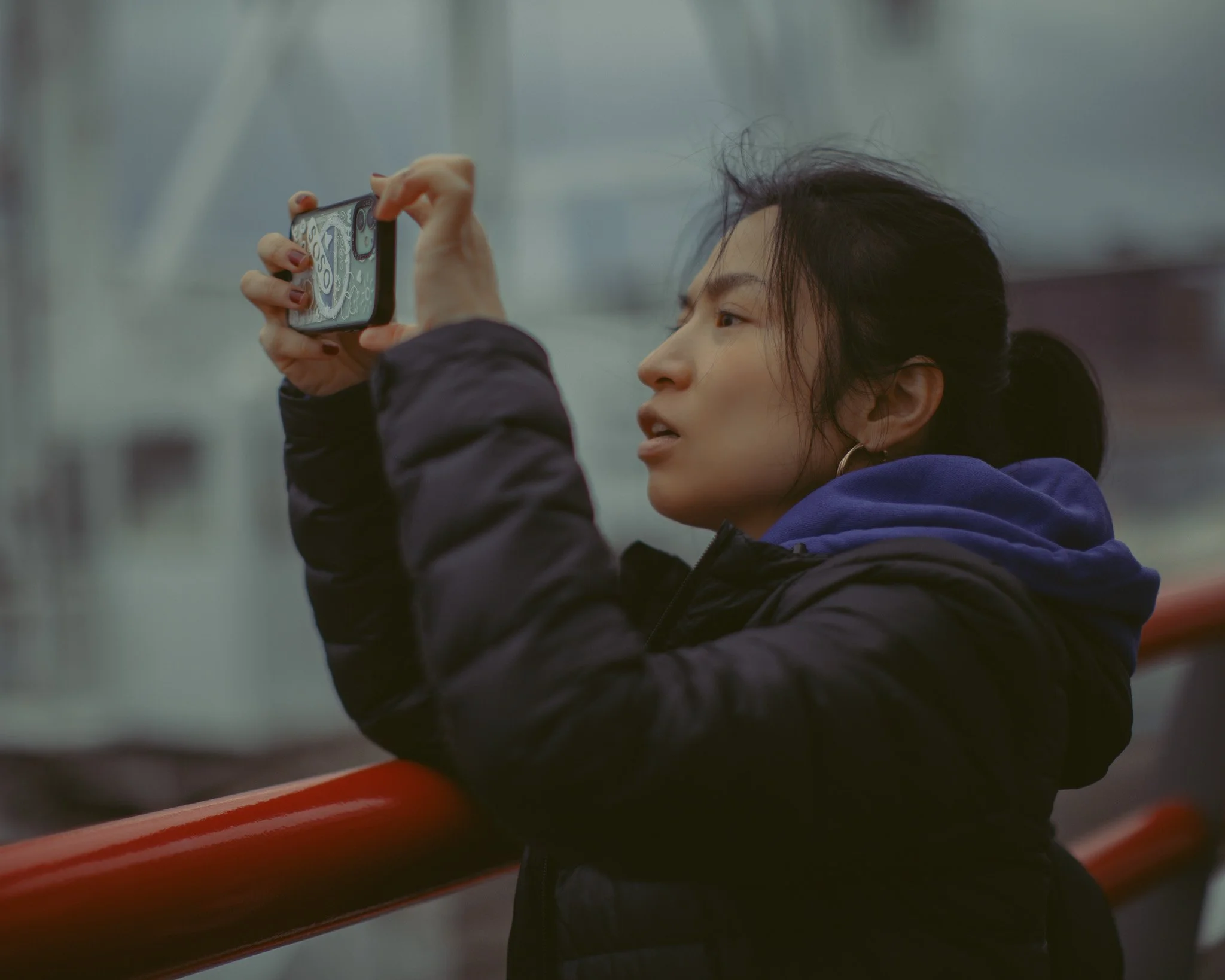 kushphoto-japan-woman-phone-ferry-railing-2025.jpg