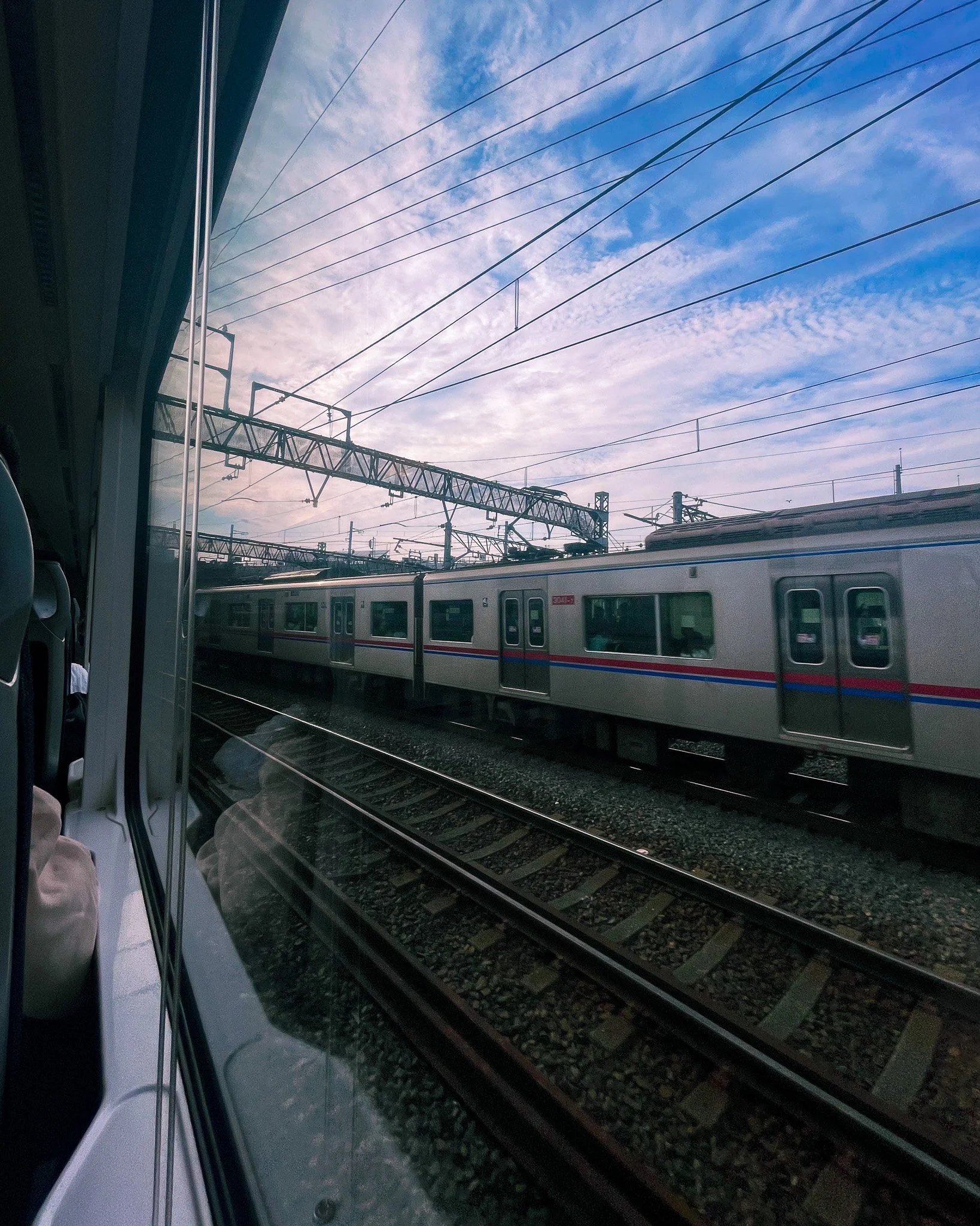 kushphoto-japan-train-window-tracks-sky-2024.jpg