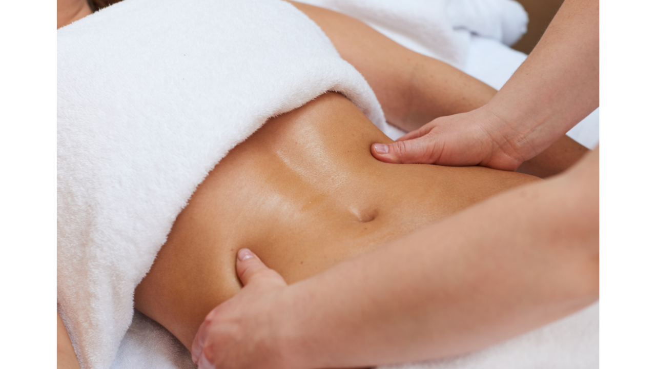 Close-up of a woman receiving a neck massage while lying down, with a focus on her face and hands.