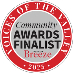 Circular badge with red border and white background, stating 'Votes of the Valley Community Awards Finalist 2025 The Valley Breeze'.