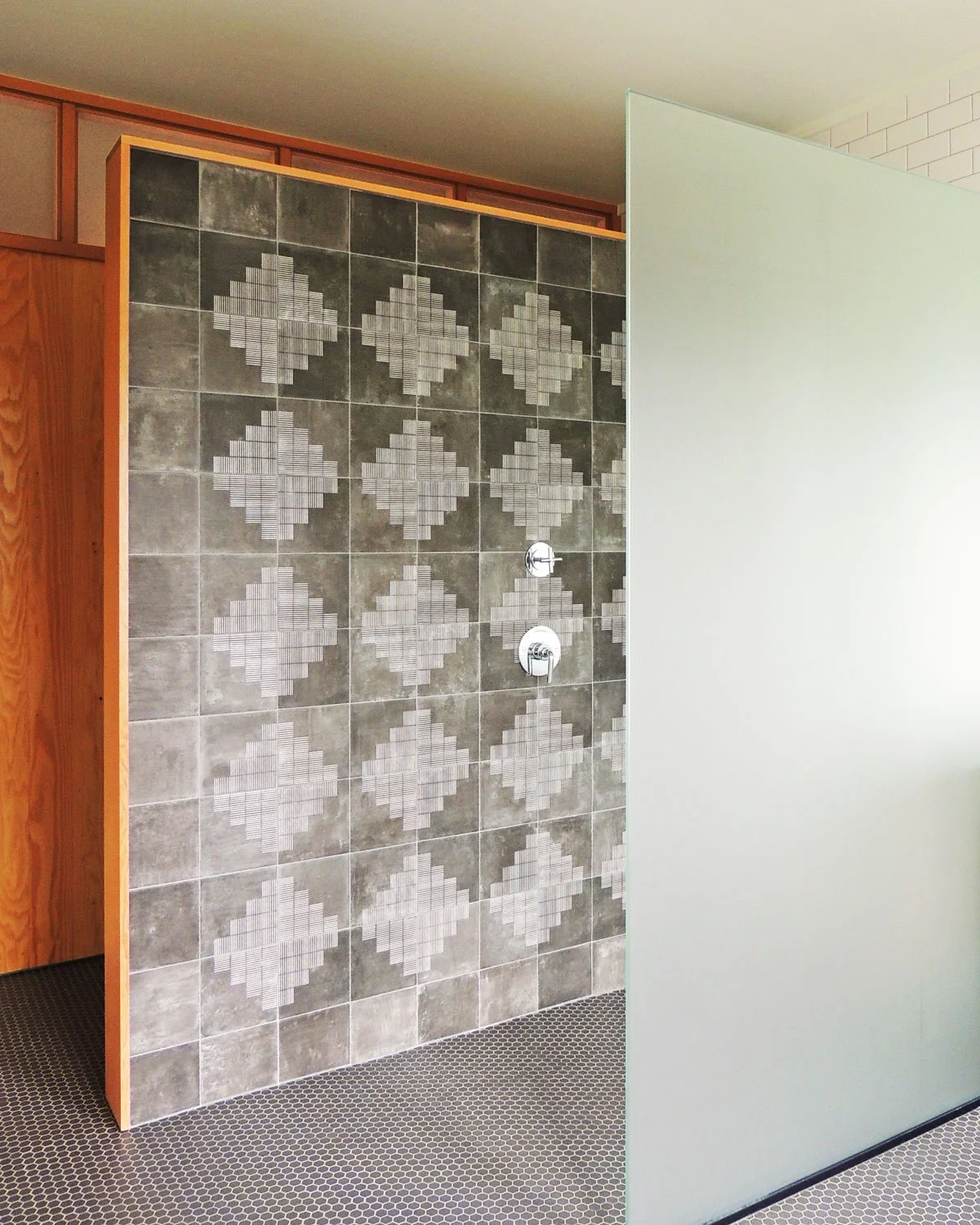 Modern bathroom with a mosaic tile wall, a frosted glass partition wall, and a wooden wall.