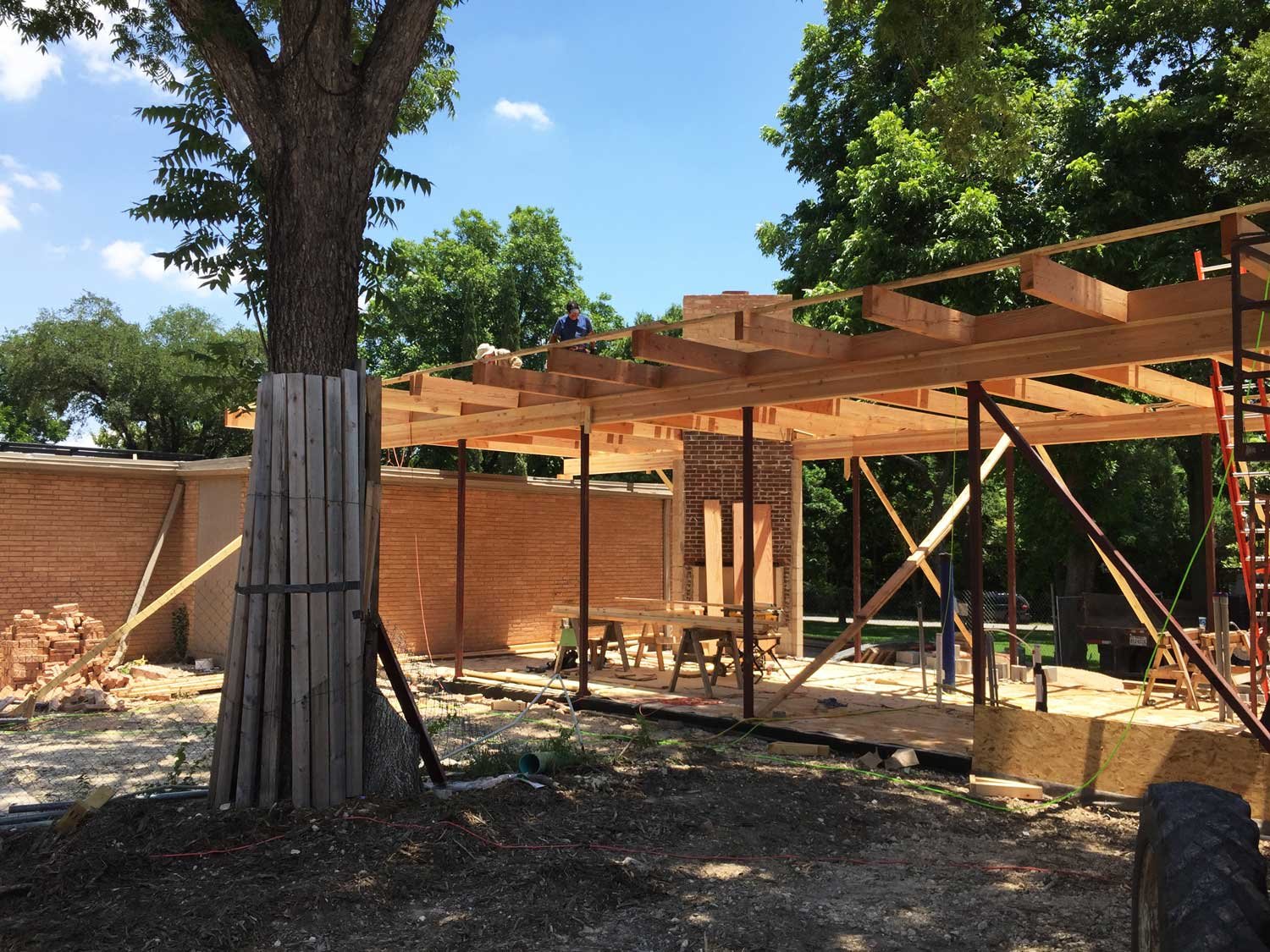 A partially complete modern home addition with wood and steel framing.