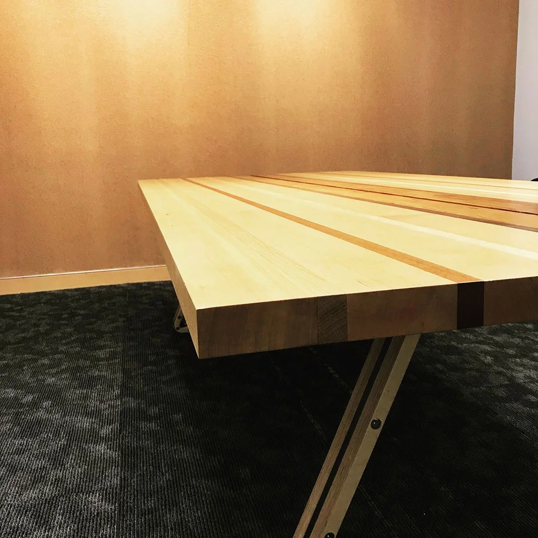 Wooden table with edge-joined slab top.
