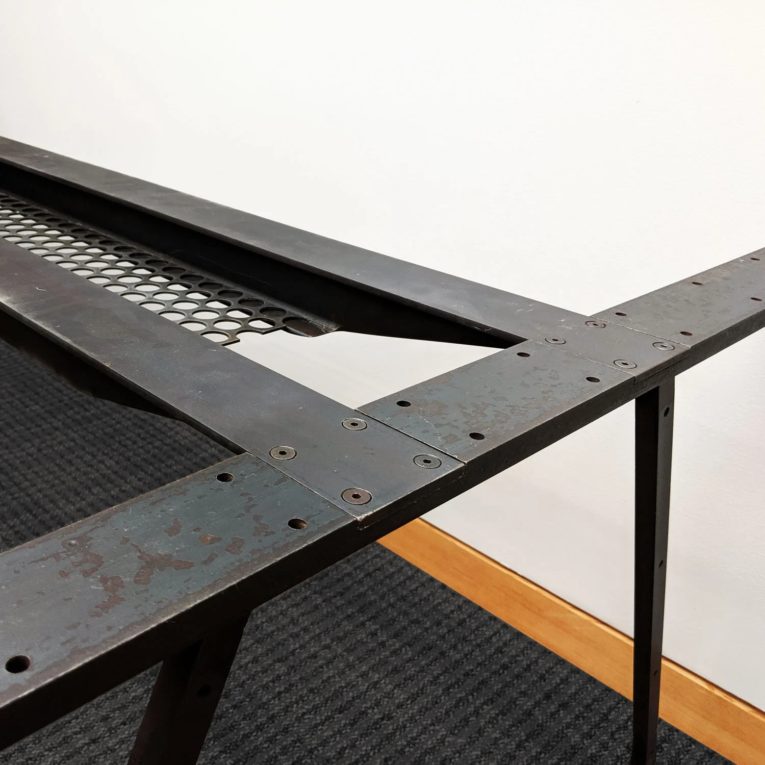 Close-up of a metal table frame assembly.