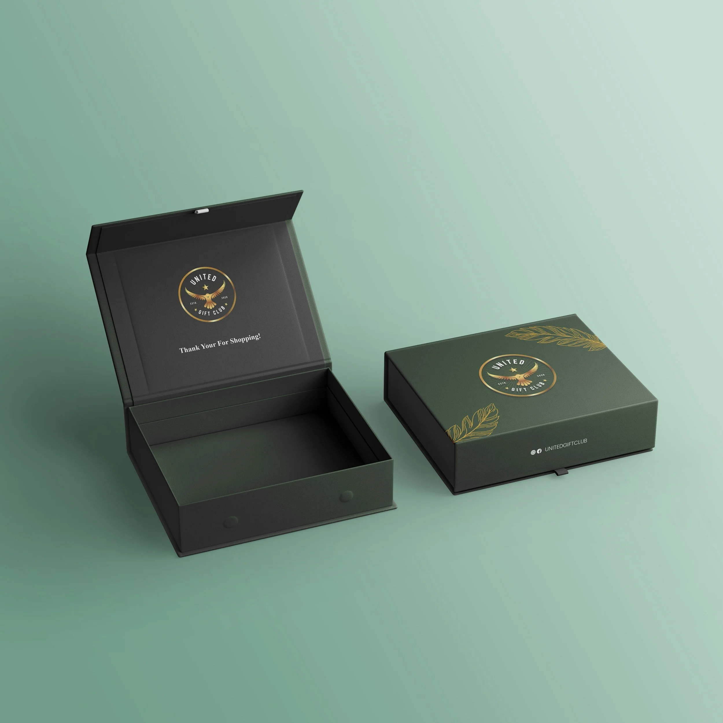 Open and closed dark green cardboard gift boxes with a logo of an eagle and the words "United Gift Club" inside the lid, sitting on a light green surface.
