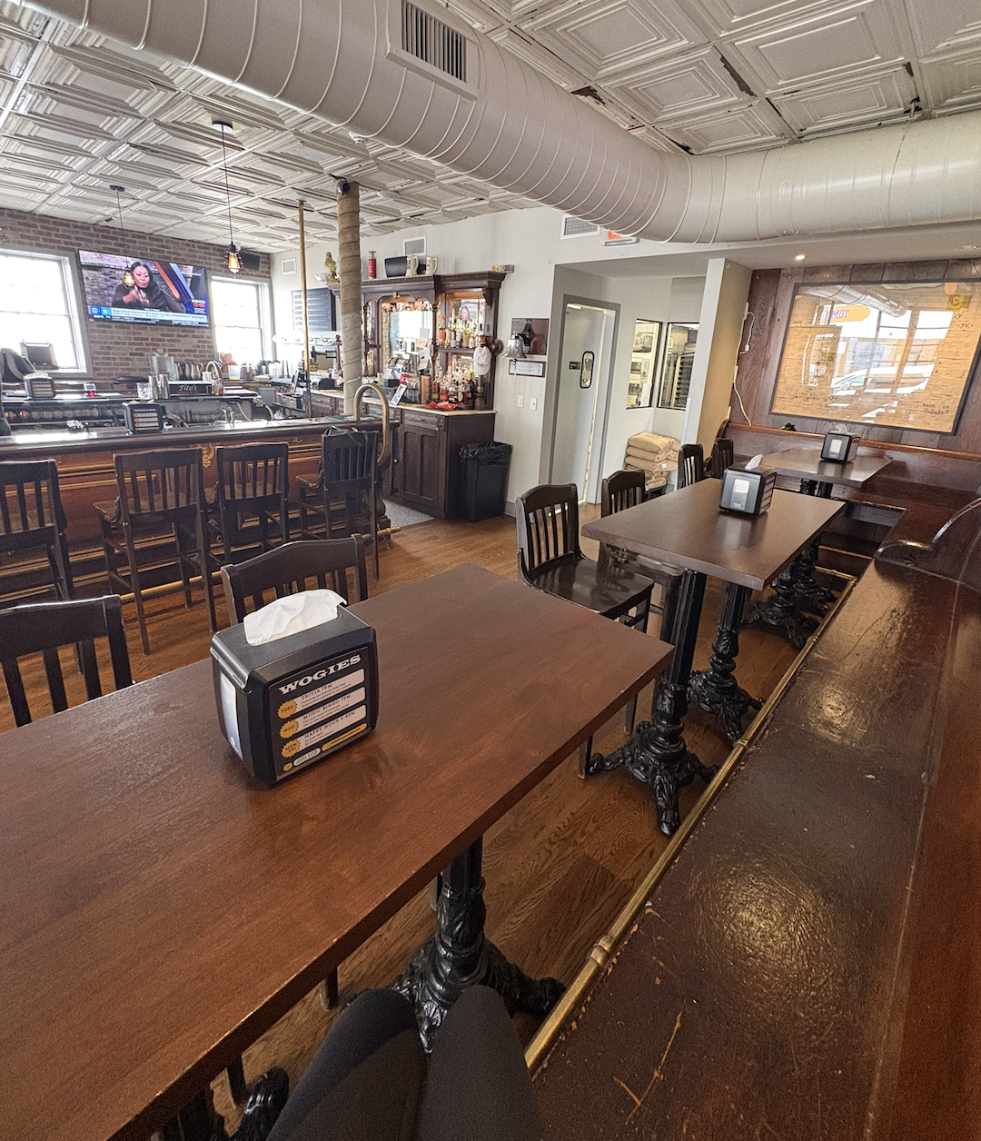 High-top seating area at Wogies Katonah near the bar with tables for groups