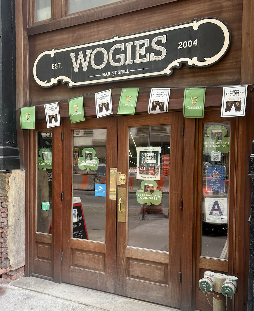 Entrance to Wogies Financial District with wooden doors and a Wogies sign above.
