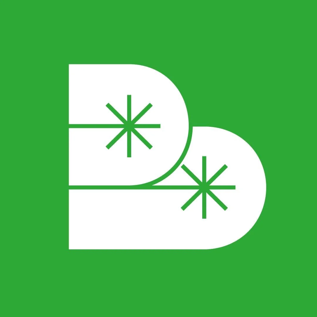 Green background with two white stylized letter D shapes overlapping, each with a green snowflake-like star in the middle.