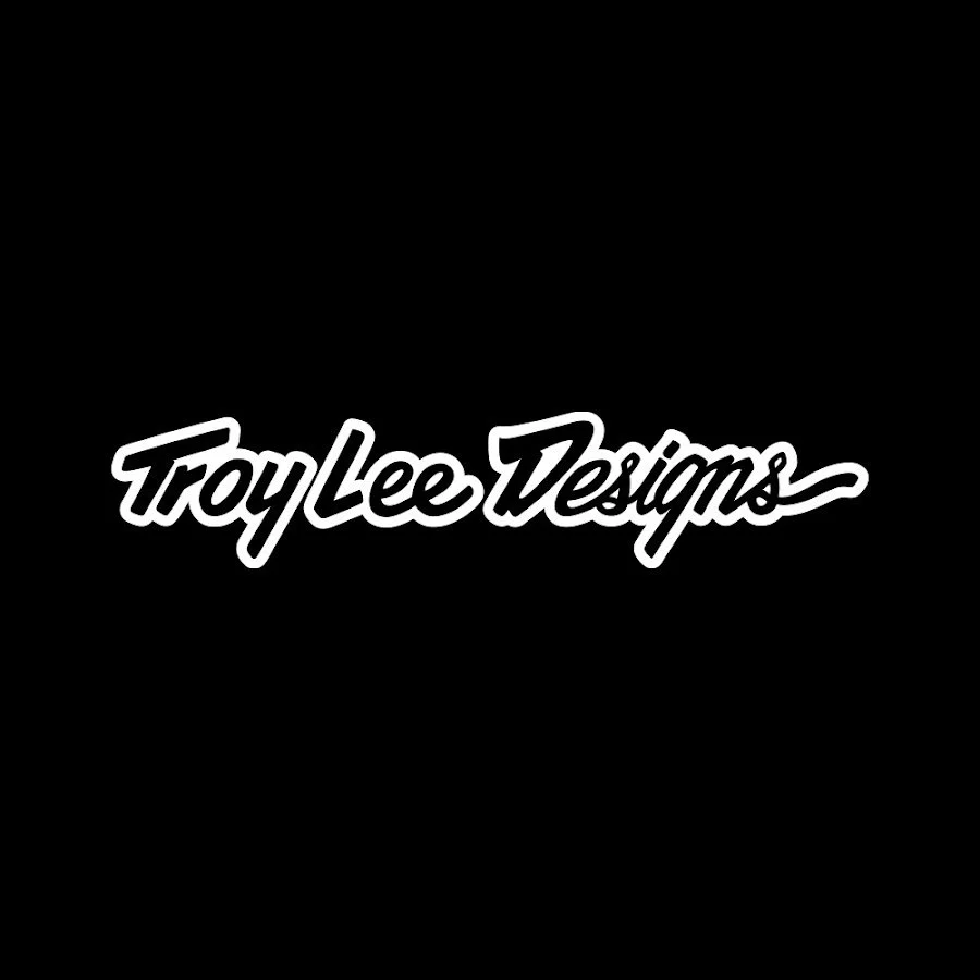 Black background with white cursive text that reads 'Troy Lee Designs'.