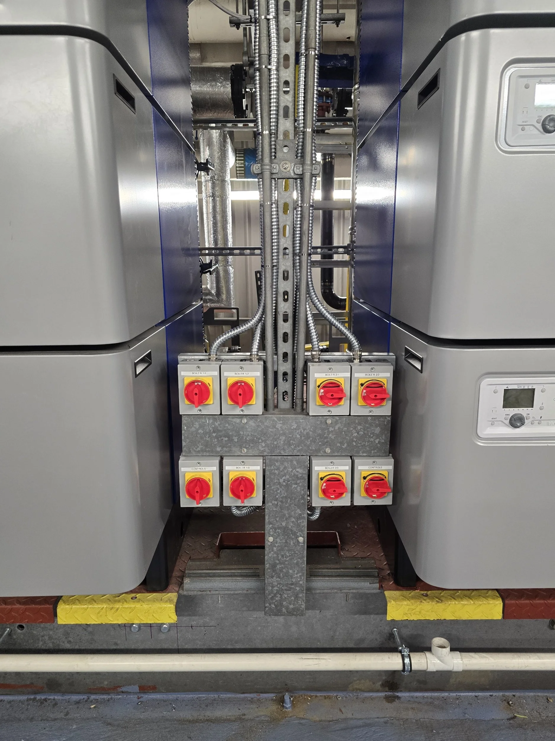 Industrial electrical control panel with electrical switches and wiring.