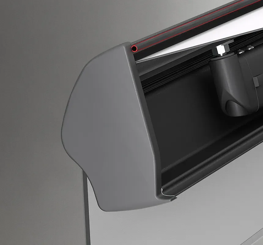 Close-up of a black and gray window roller shade cassette with red trim and mounting hardware