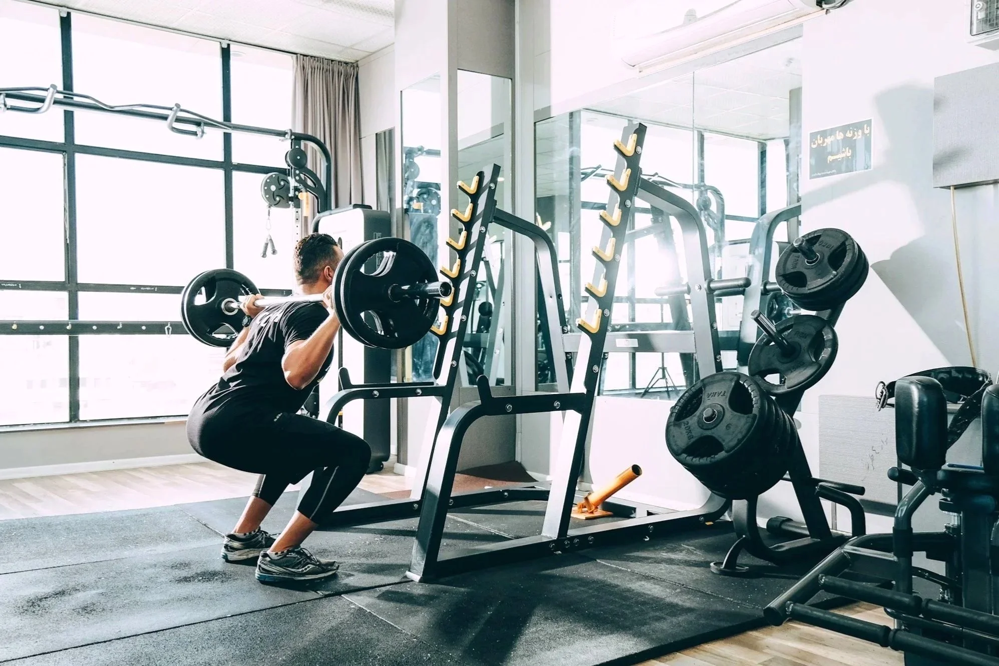 Man lifting weights in a gym.