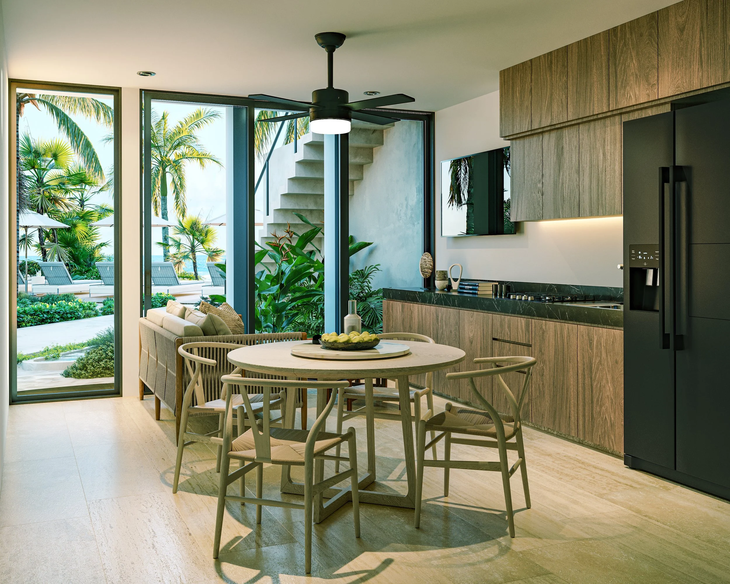 Interior de una casa moderna con vista a un área exterior con palmeras, sillones y sombrillas.
