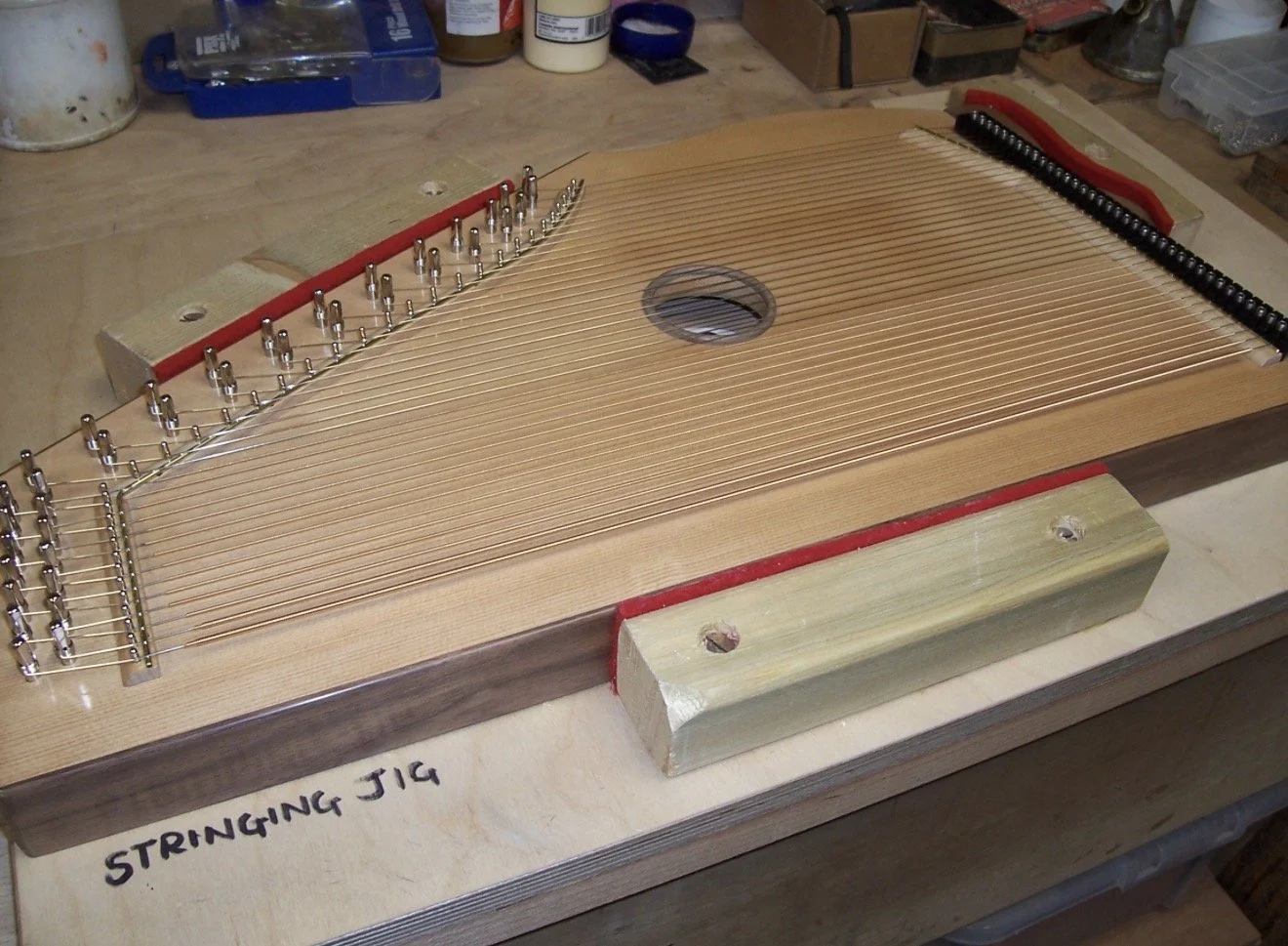 Image of harp after undergoing the polishing process, making and gluing on the bridges, installing the bridge pins, polished bridge caps and stringing up 