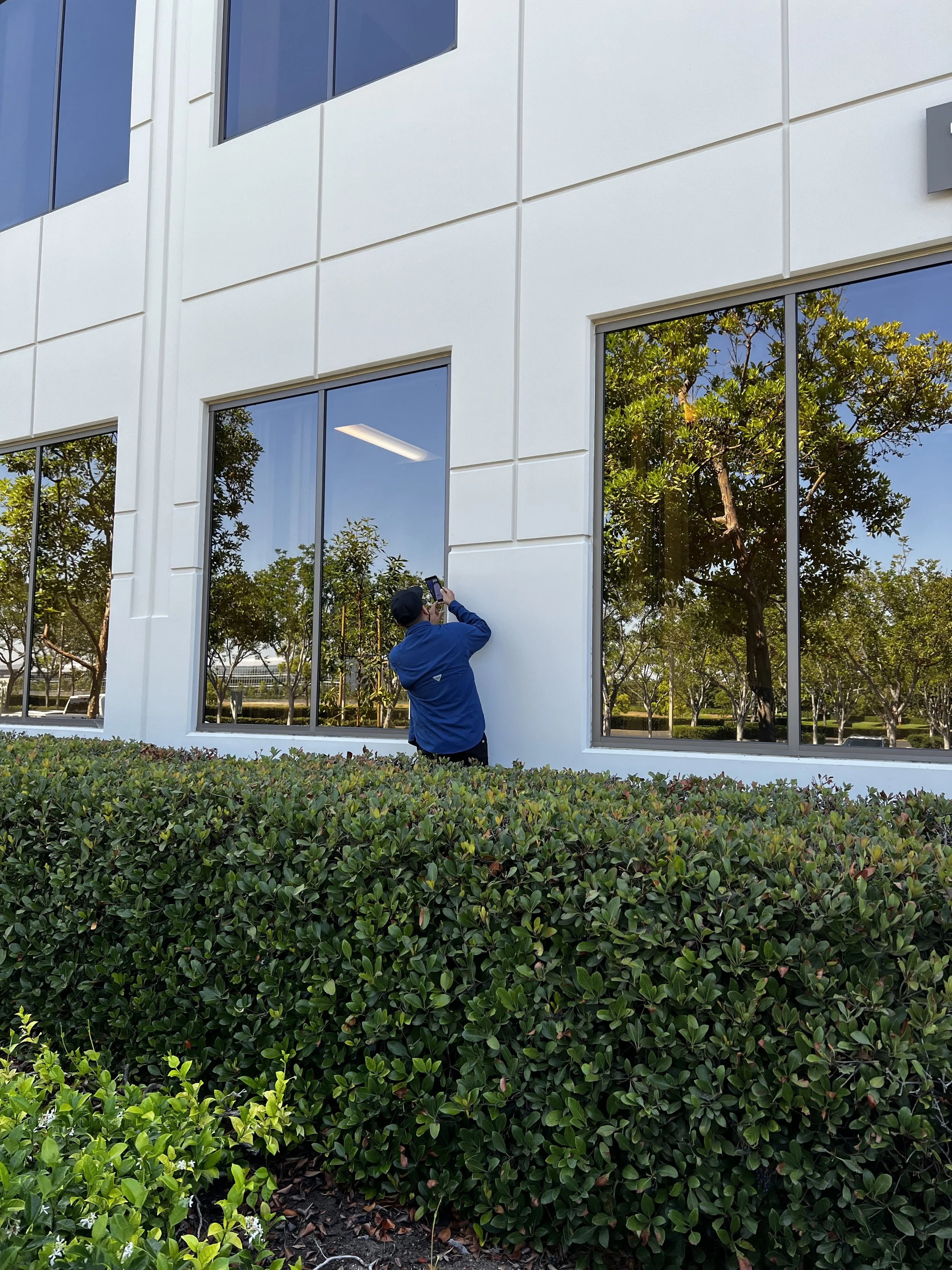pest control technician inspecting a commercial building for ants.