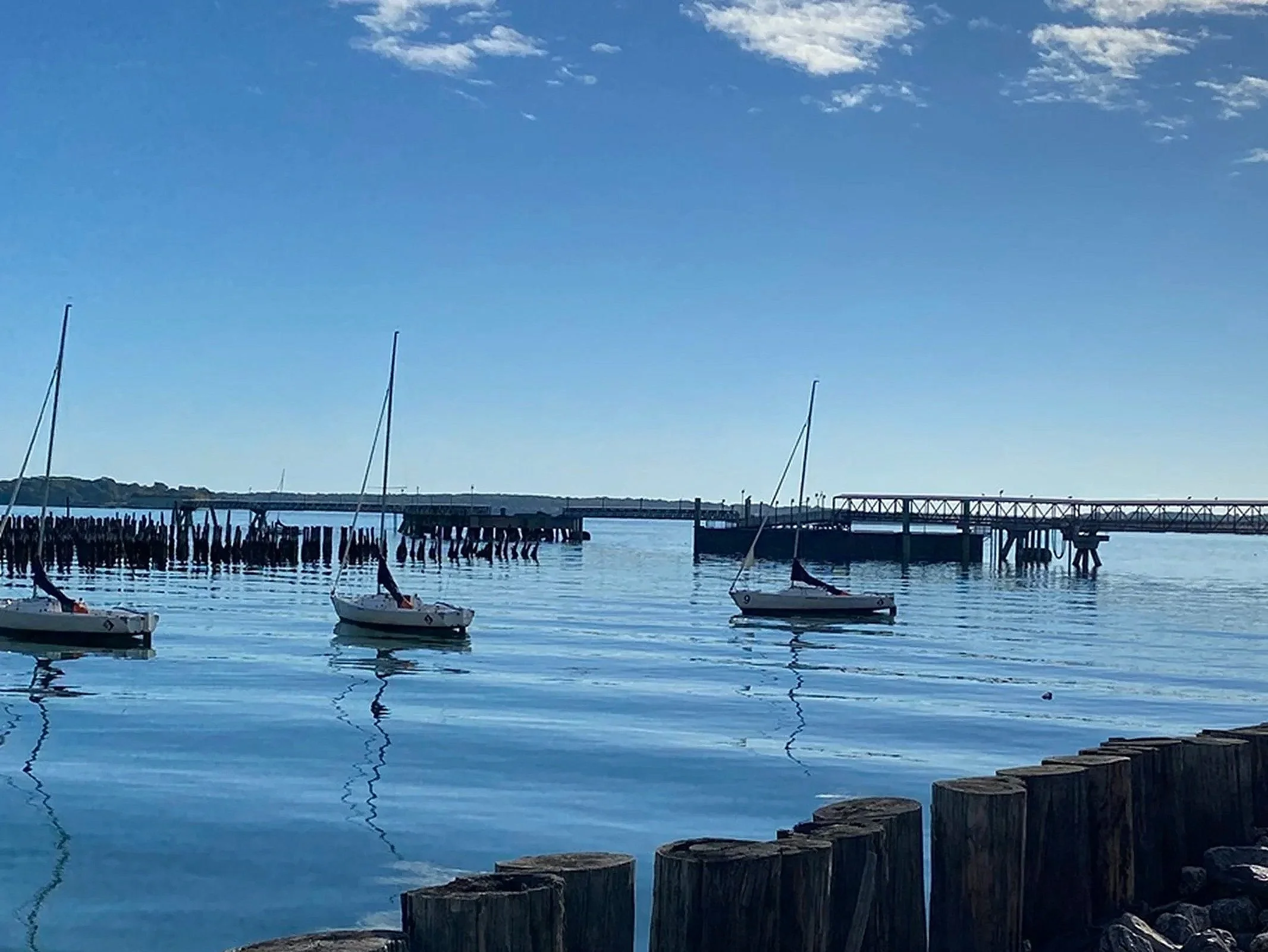Three Sailboats on Calm Harbor - Portland, ME

Three small sailboats float gently on the calm waters of Portland Harbor near a historic pier and breakwater. The peaceful maritime scene captures the relaxed rhythm of sailing life along the Maine coast