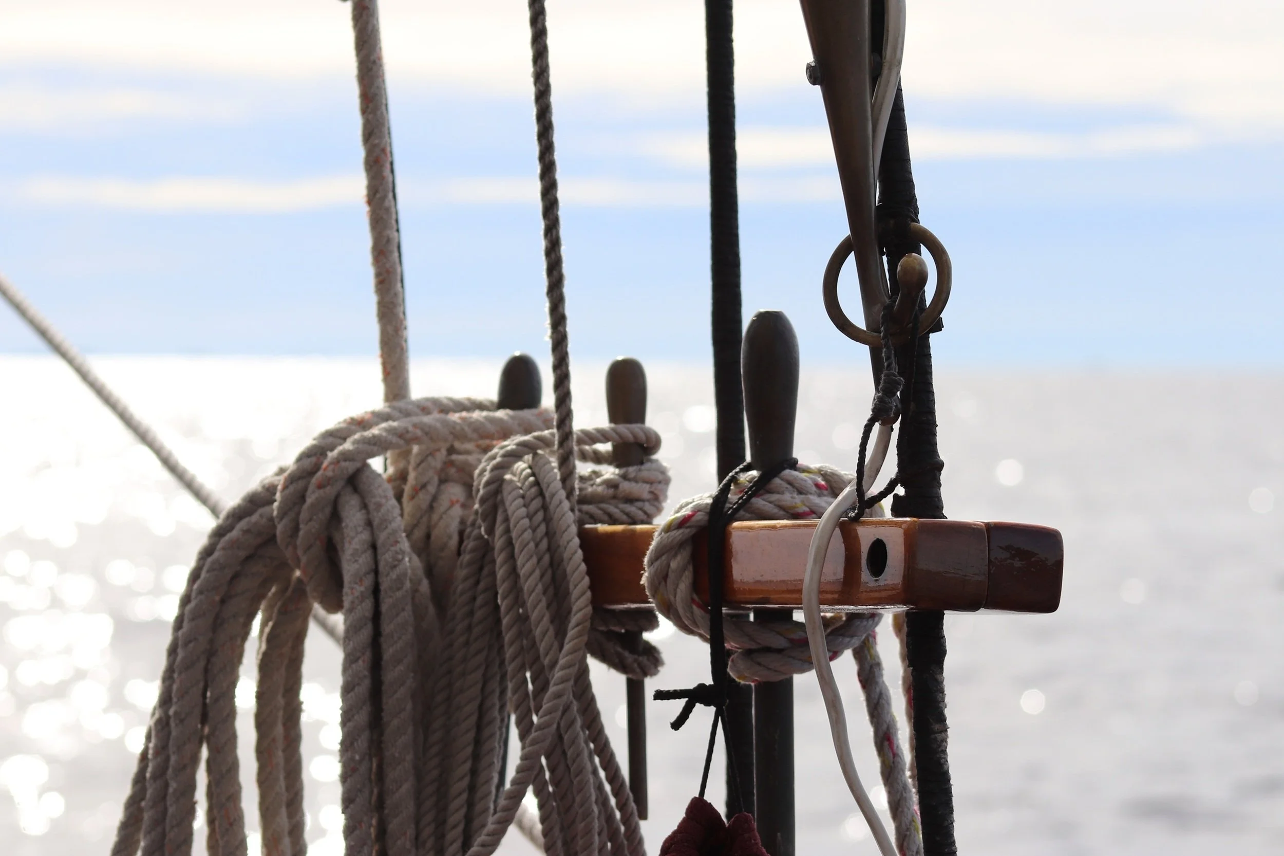 Tethered Light: Coiled ropes, wooden fittings, and shimmering water come together in a quiet moment of maritime detail and craftsmanship. Rich textures and gentle coastal light create an image that brings warmth, authenticity, and nautical character 