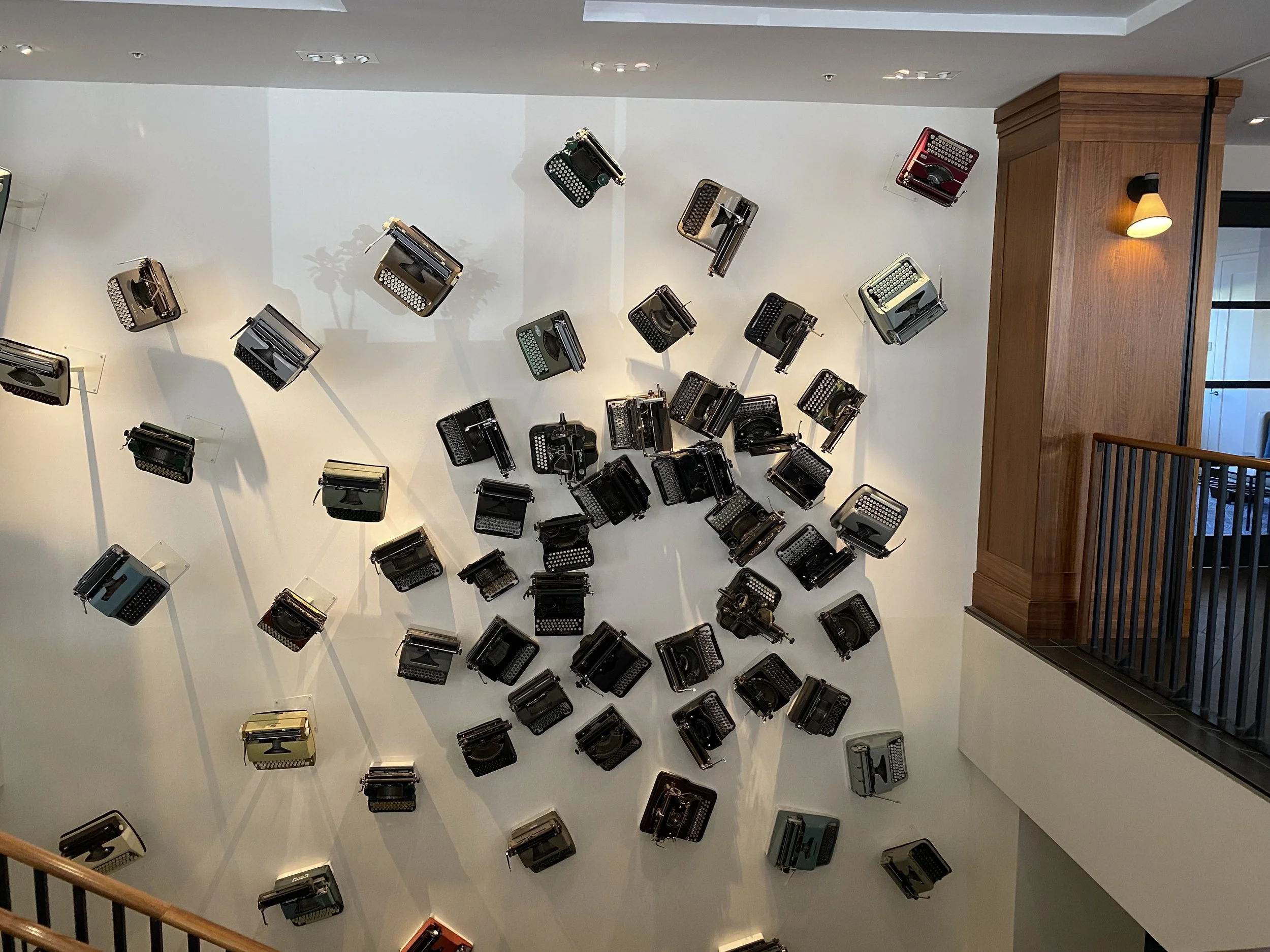 Typewriter Wall - Stories in Motion

A dynamic installation of vintage typewriters spreads across a clean white wall, transforming functional objects into sculptural art. The composition plays with movement, shadow, and nostalgia—bridging history and