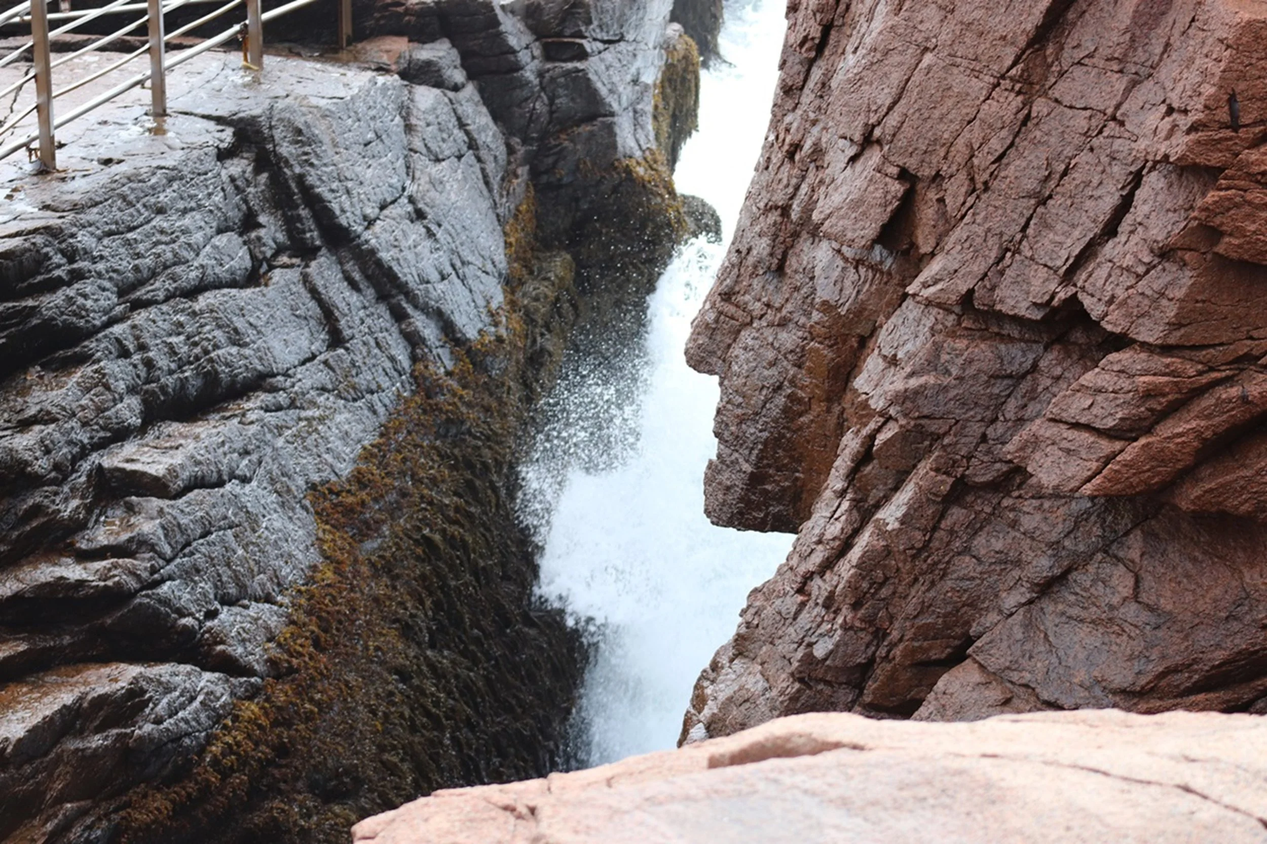 Between the Walls

A narrow channel carved between dark granite walls funnels the tide into a rushing corridor of white water. The contrast between the rigid, layered rock and the fluid motion of the sea creates a striking study in force and restrain
