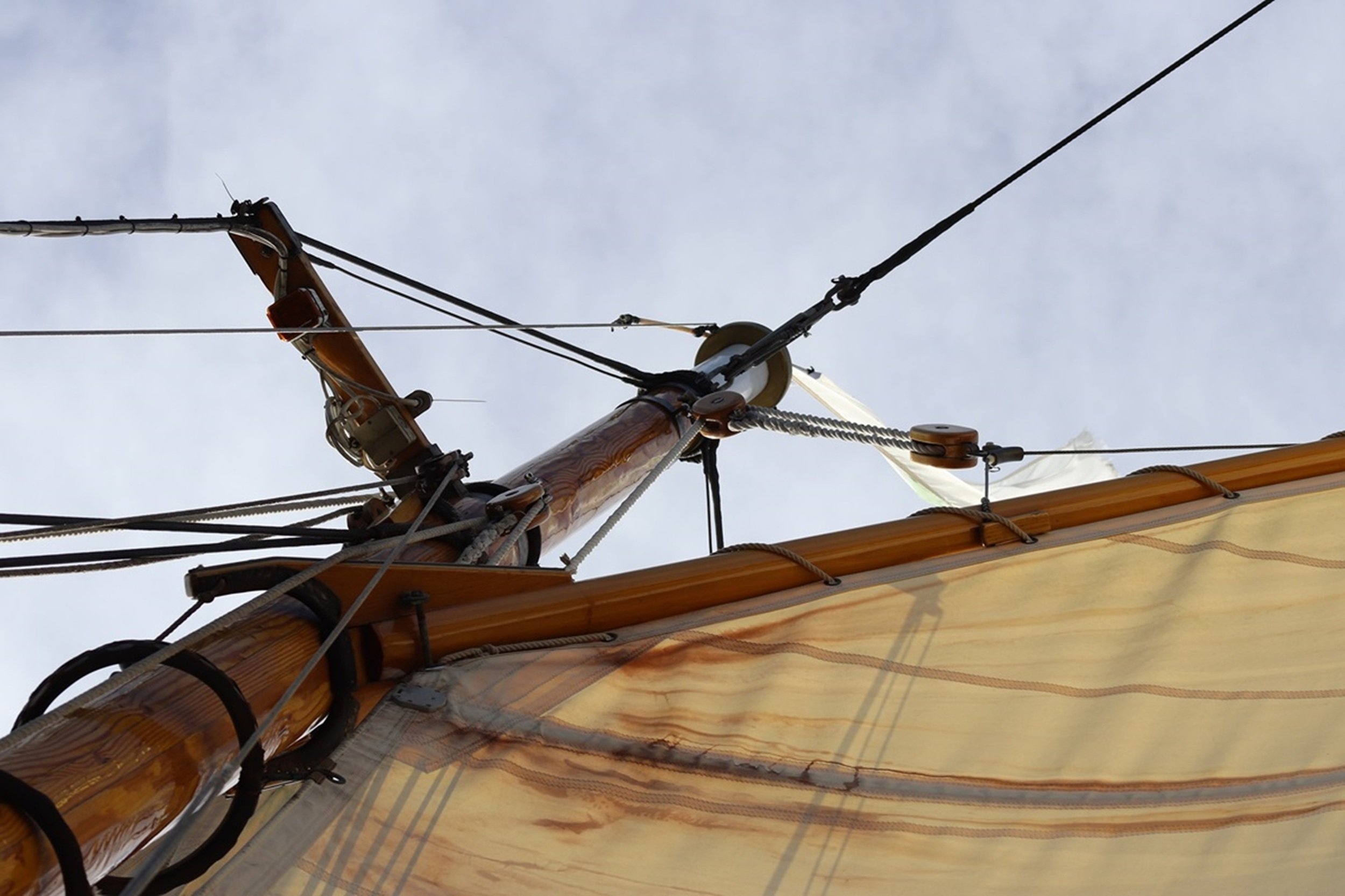 Lines to the Sky: Rigging, spars, and sailcloth converge in a dynamic composition that draws the eye upward through the architecture of a traditional sailing vessel. The interplay of line, form, and craftsmanship creates a striking image well suited 